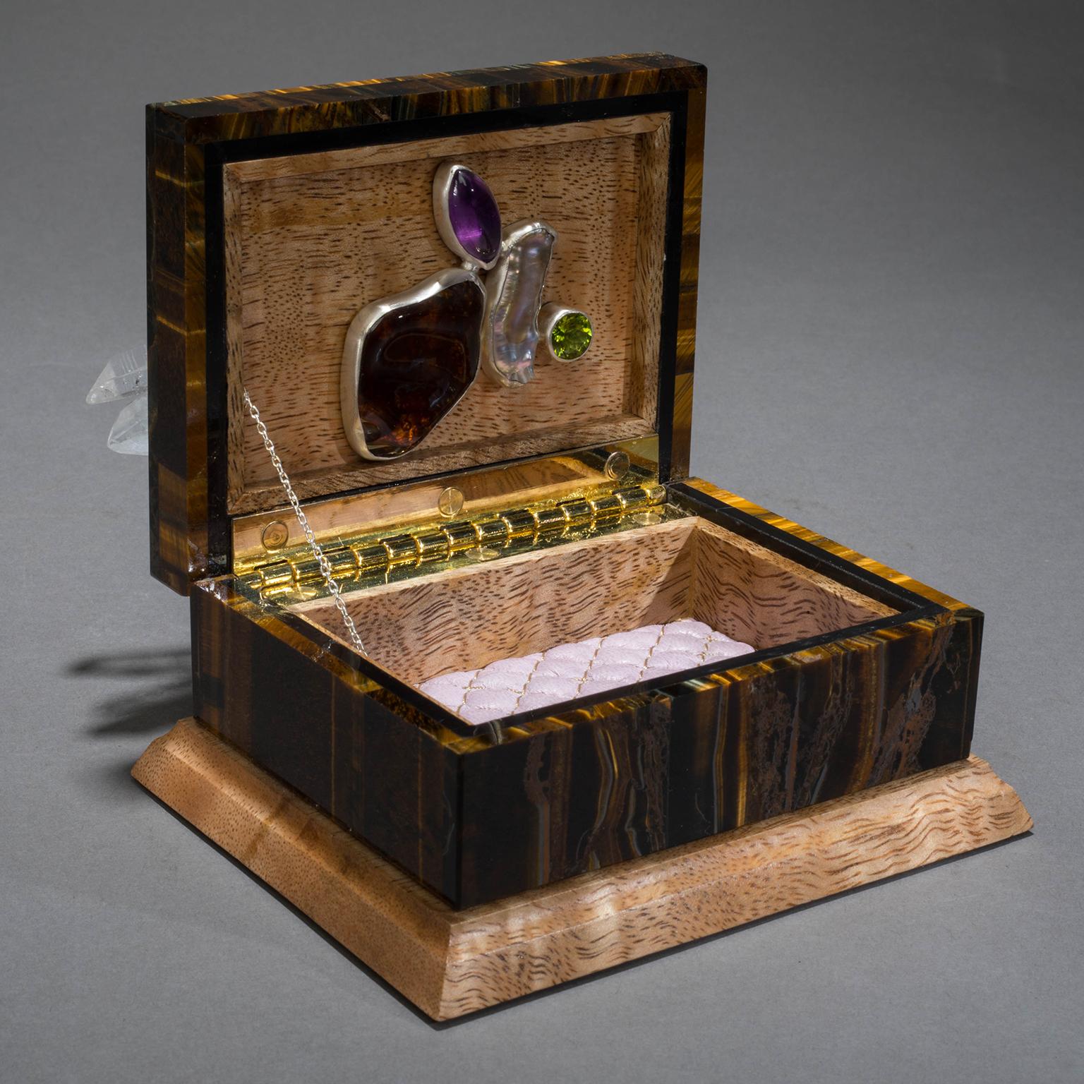 BLING BOX 2

In Studio Greytak’s Bling Box 2 nature’s imagination is on full display. A slice of heavenly raw amethyst spun through a whirlwind of quartz crystal blooms as a flawless gem atop a decidedly earthy tiger’s eye box. Nestled against the