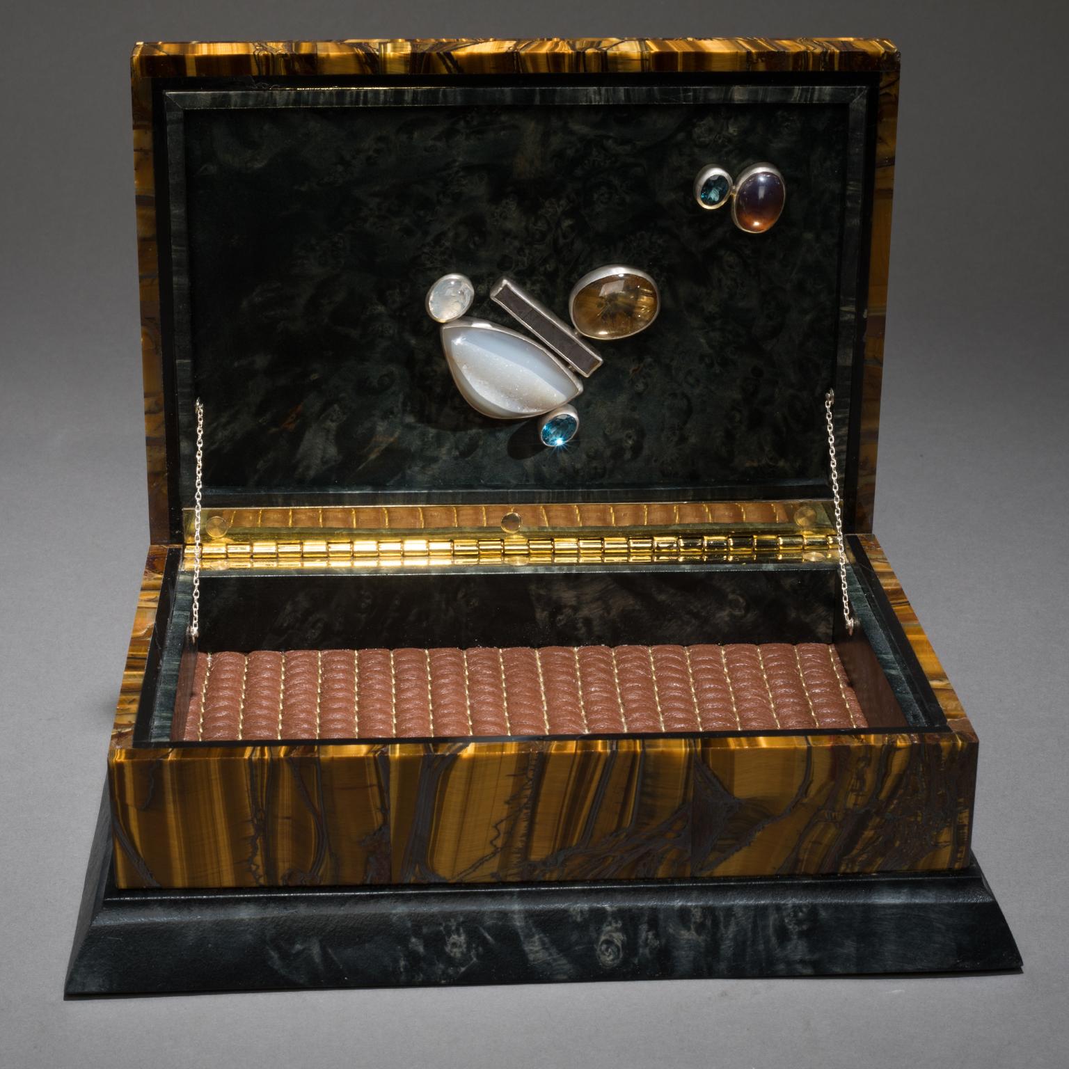 BLING BOX 6

Studio Greytak’s Bling Box 6 brings together opposing yet complementary energies. A box of stunning tiger’s eye anchors the piece, bringing mental clarity. Delicate fluorite clears the atmosphere of confusion. Here it sits atop a rare