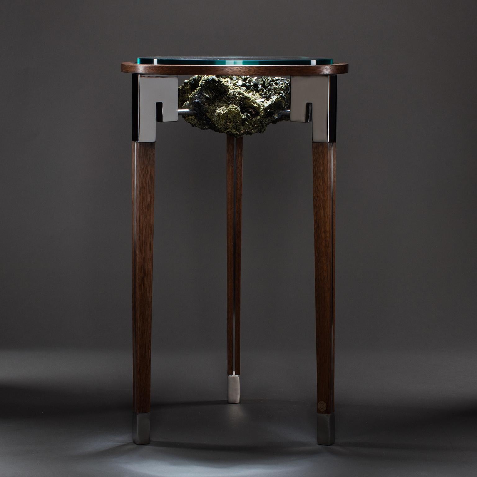 CLASSIC PEEKABOO TABLE 1

In Studio Greytak’s Classic Peekaboo Table 1, dark, lustrous epidote crystals sit suspended in their matrix between three slender columns like an ancient relic displayed at the altar of an Ionic temple. Tapered walnut legs