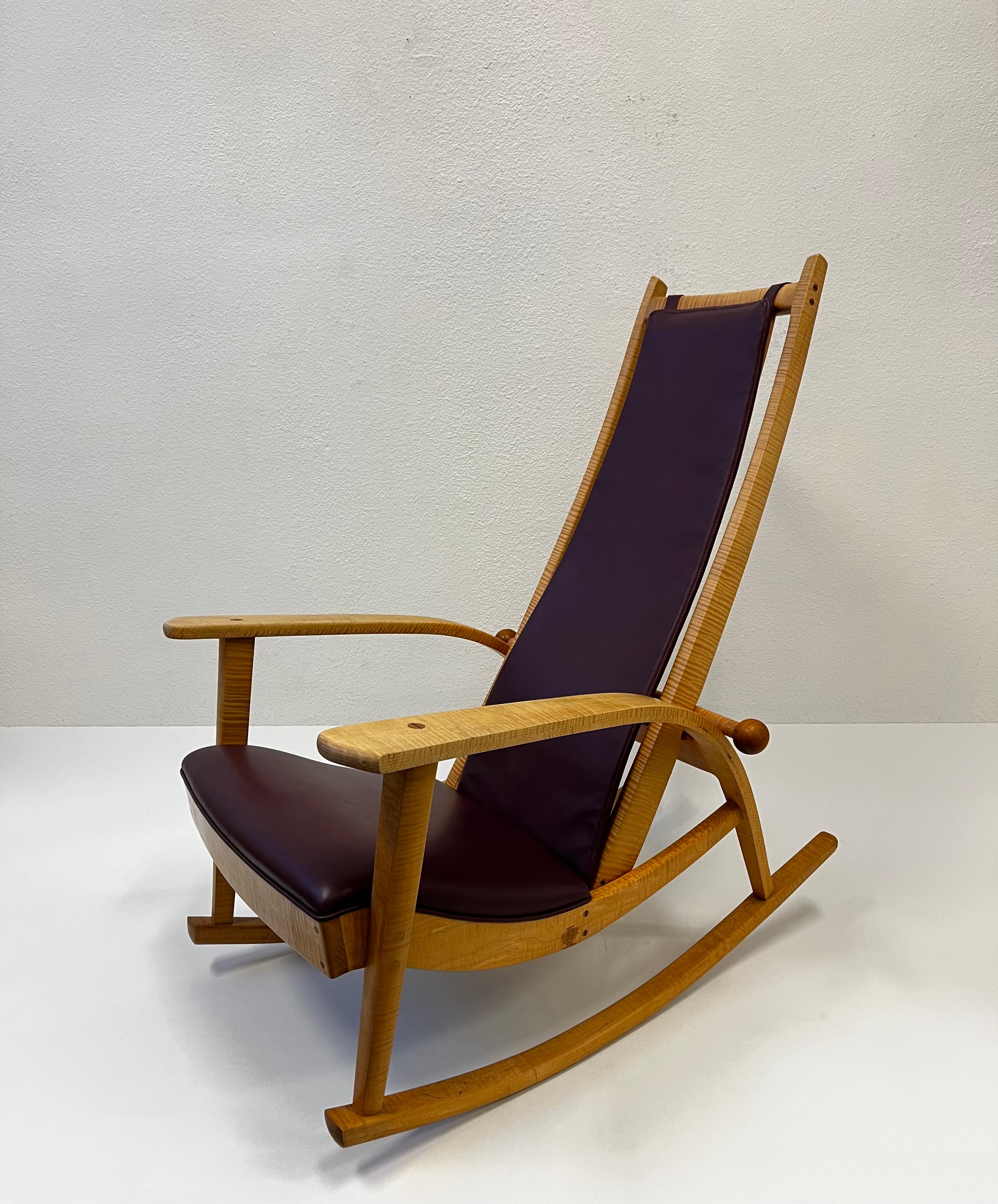 Studio hand crafted tiger maple and leather rocking chair by Robert Erickson. 
In original condition shows minor wear consistent with age. 
Signed and numbered(see detail photo). 

Measurements: 39” Deep, 28.75” Wide, 43.75” High, 16” Seat, 23” Arm. 