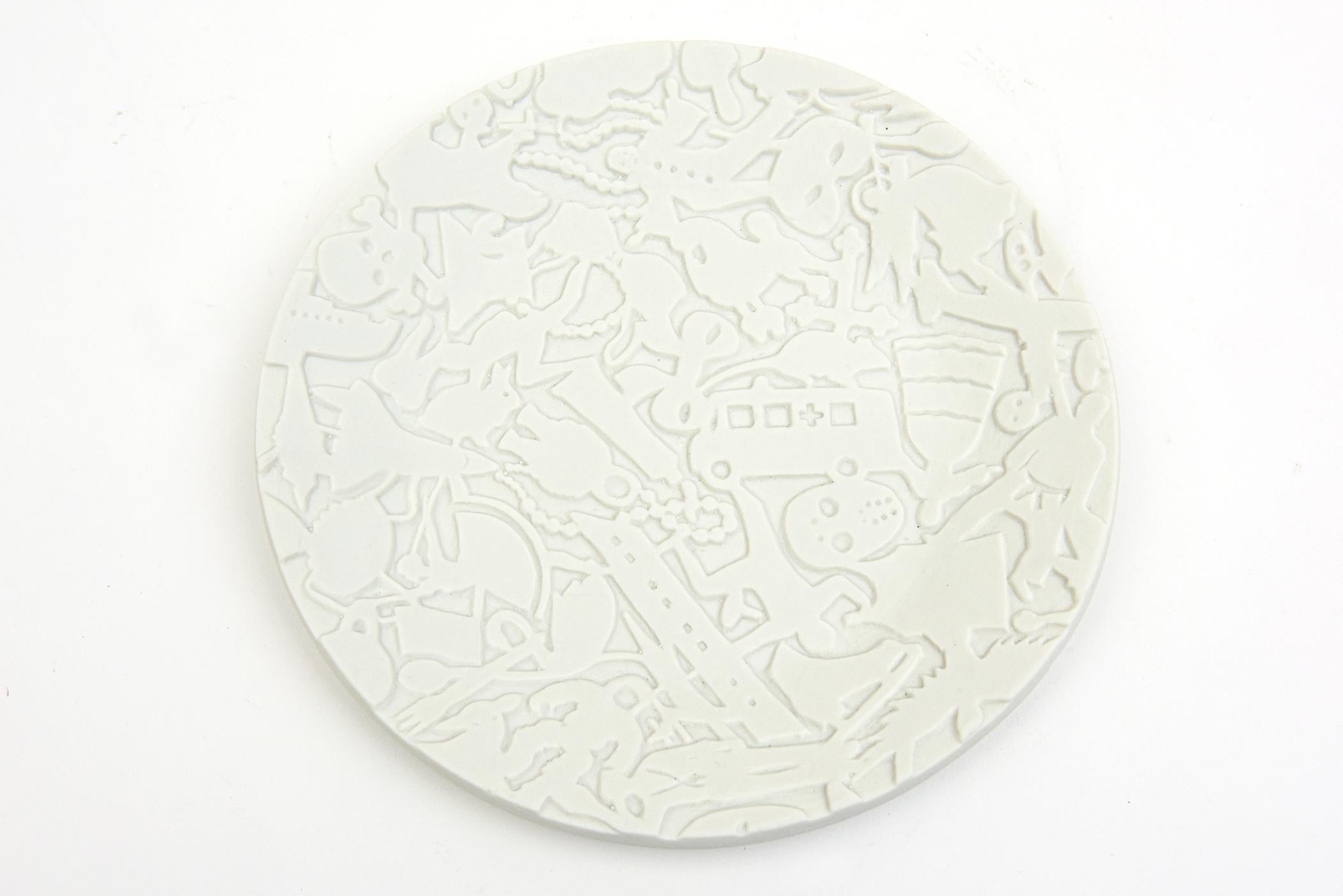 This amazing limited edition porcelain textural relief plate is a piece of art and sculpture with coded messages of things, objects and symbols all floating together on a white unglazed matte porcelain object plate. it is the work of Studio Job from