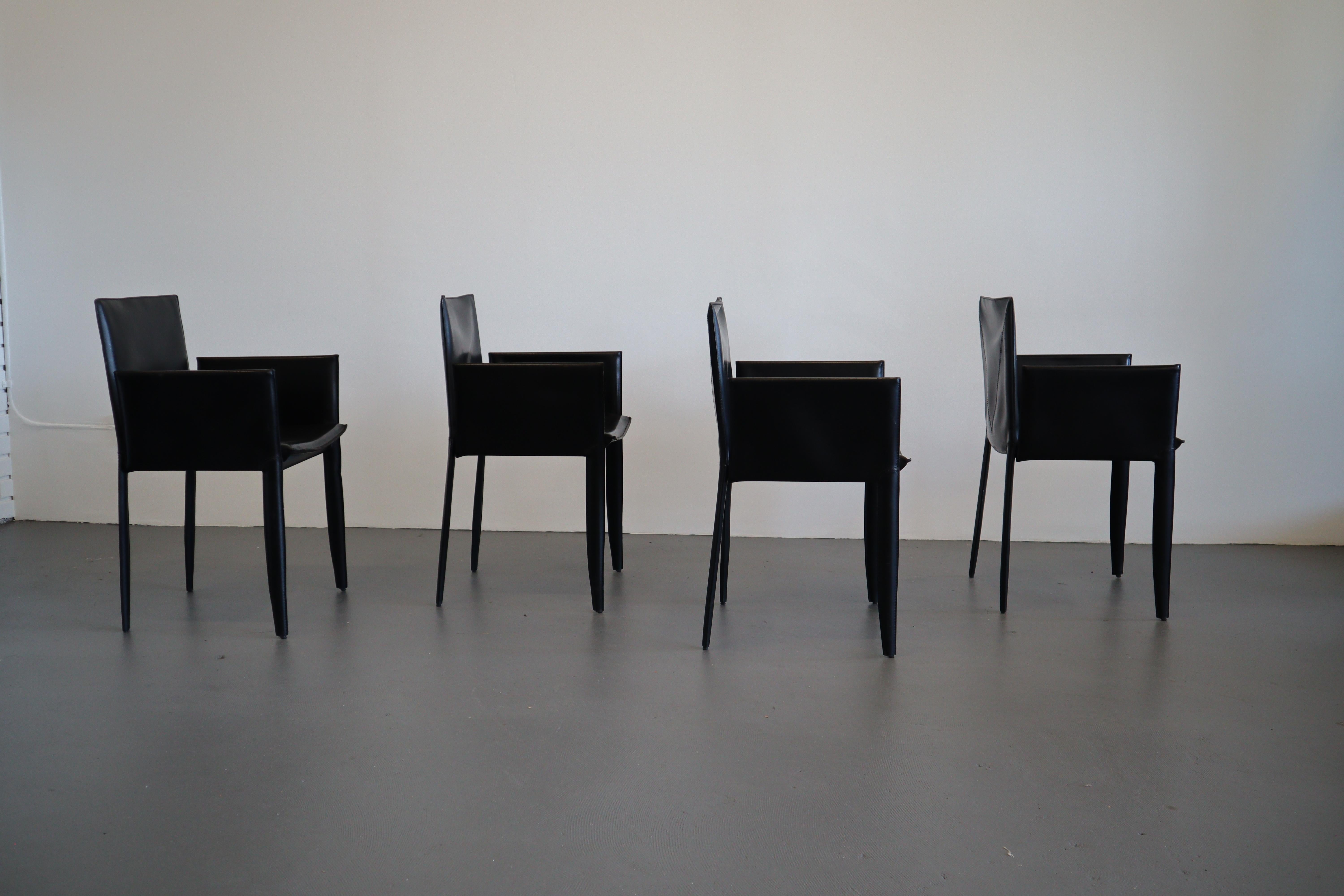 A set of four modernist Italian leather dining chairs by Cattelan Italia. Beautifully made with supple black leather and detailed stitching. Elegant and refined design that is a compliment to most styles. Set of harder to find armchairs in great