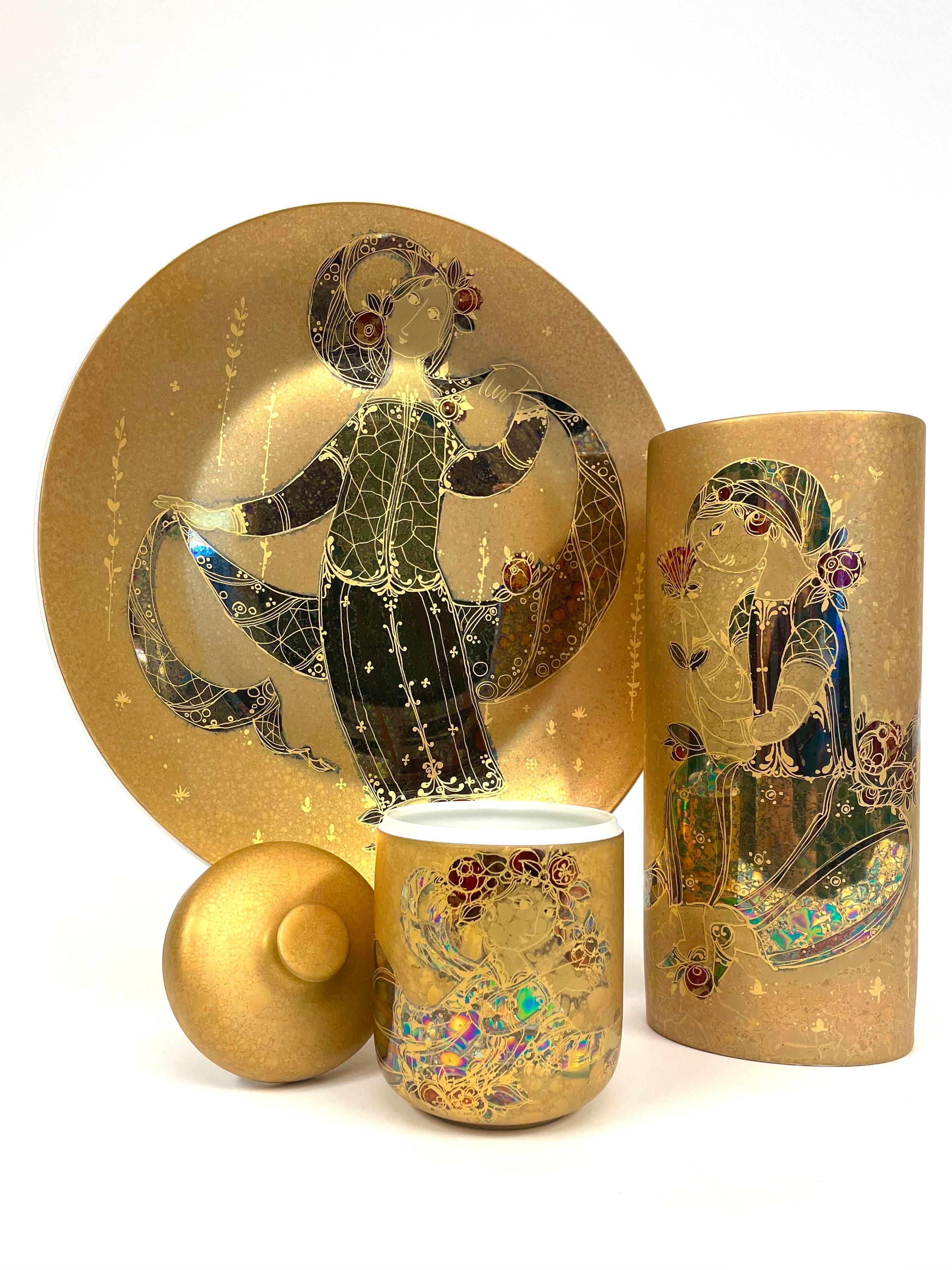 This is a German porcelain collection from Rosenthal and designed by the Dane Bjørn Wiinbladh.
It consists of three hand painted and partly metal gilded pieces consisting of a large platter, a tall oval vase and a jar with a lid.

The oval of the