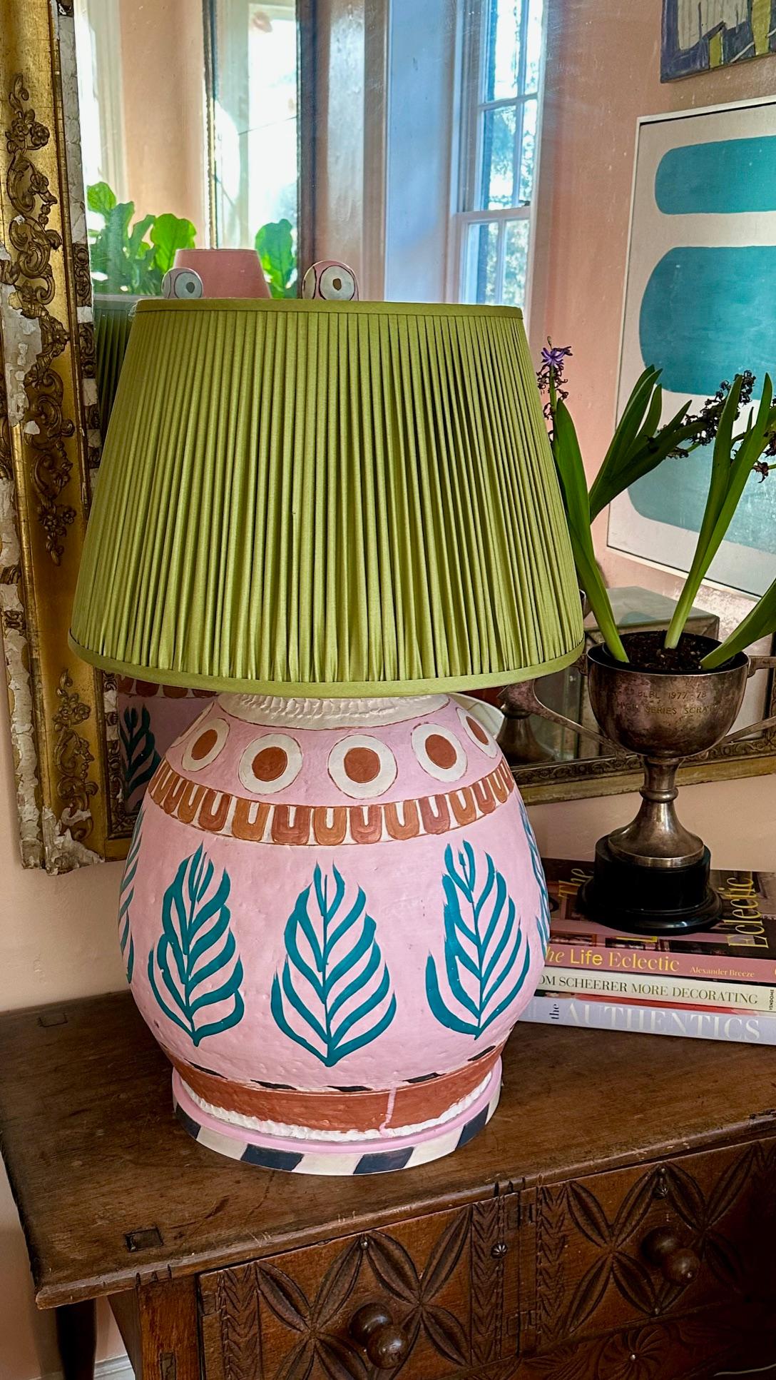 Colorful and rustic patterning on an oversized handmade form. Pink, rust, and turquoise make up the majority of colors, with banding in a black and white, Eastern inspired pattern. Rustic, imperfect shape and matte- waxed finish. Double brass socket