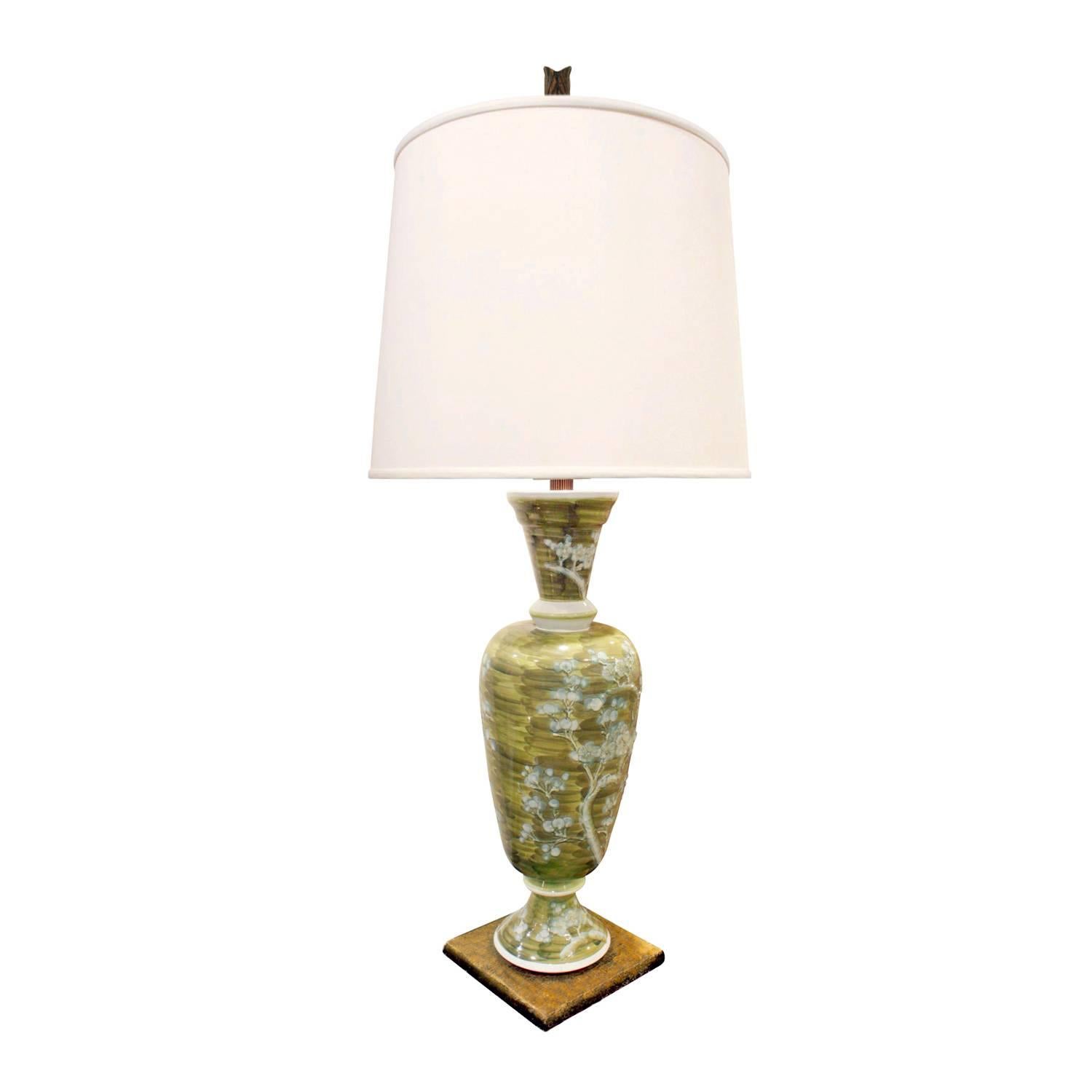 Studio made sage green porcelain table lamp with hand-painted blue flowers, on a gilded base, French, 1950s.

Measures: Shade diameter: 14 inches.