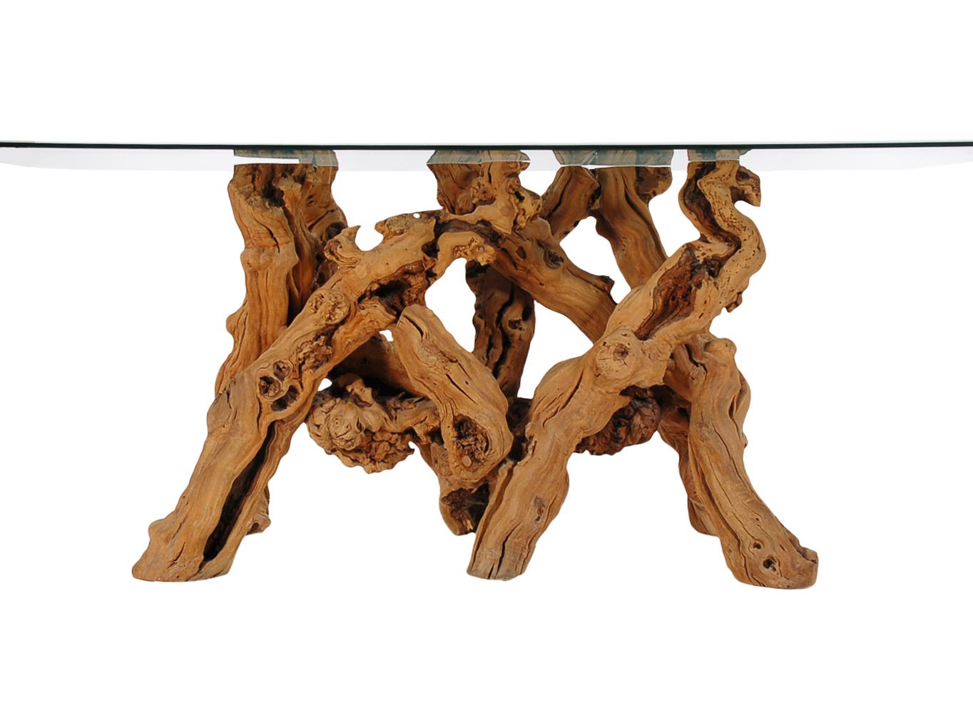 A large vintage dining table or conference table that was studio made in the early 1970s. It features a sculptural solid driftwood base with large glass top.