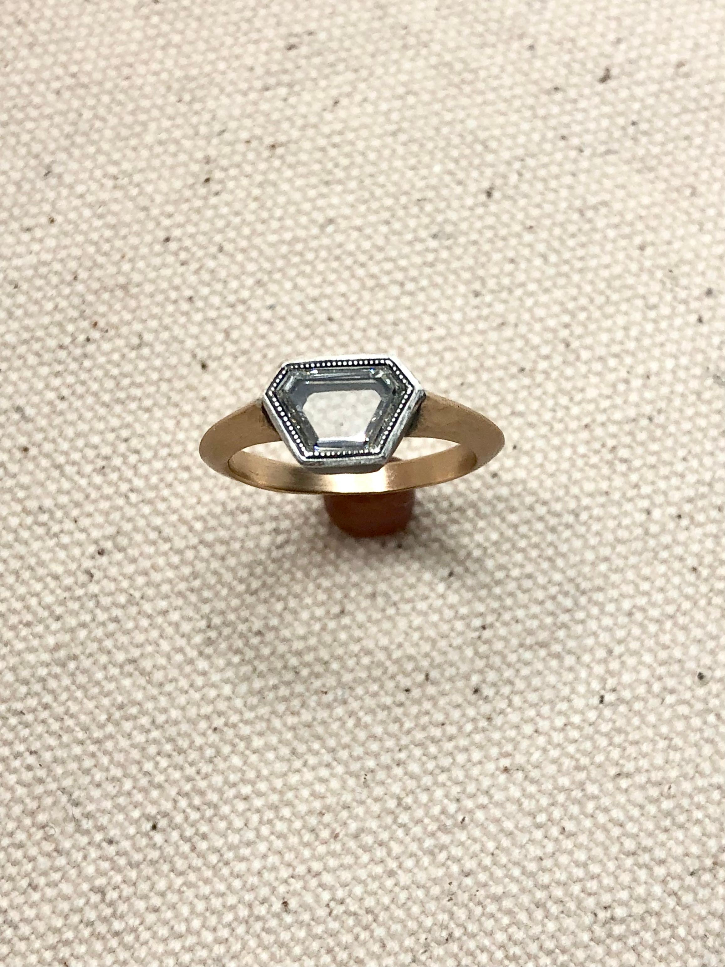 This diamond solitaire ring is a one of a kind studio made jewel constructed specifically for this unique portrait cut diamond. Inspired by Georgian design with its muted and oxidized metal tones this one of a kind ring gives a very fresh take on