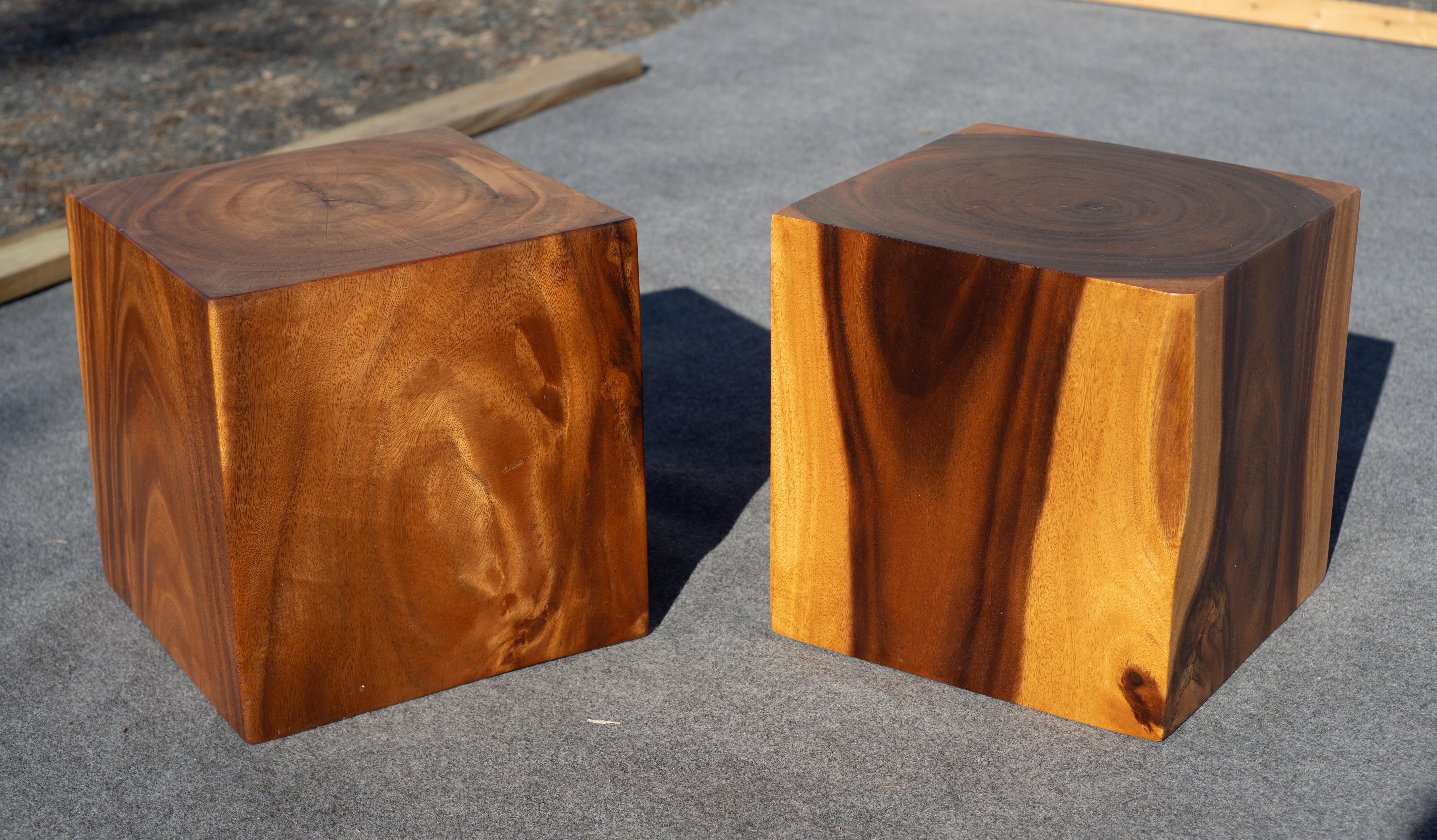 A pair of stunning solid teak cube form end or side tables. These are vintage beauties with dramatic graining and a warm patina. Each has a hollowed core with walls that are roughly 3