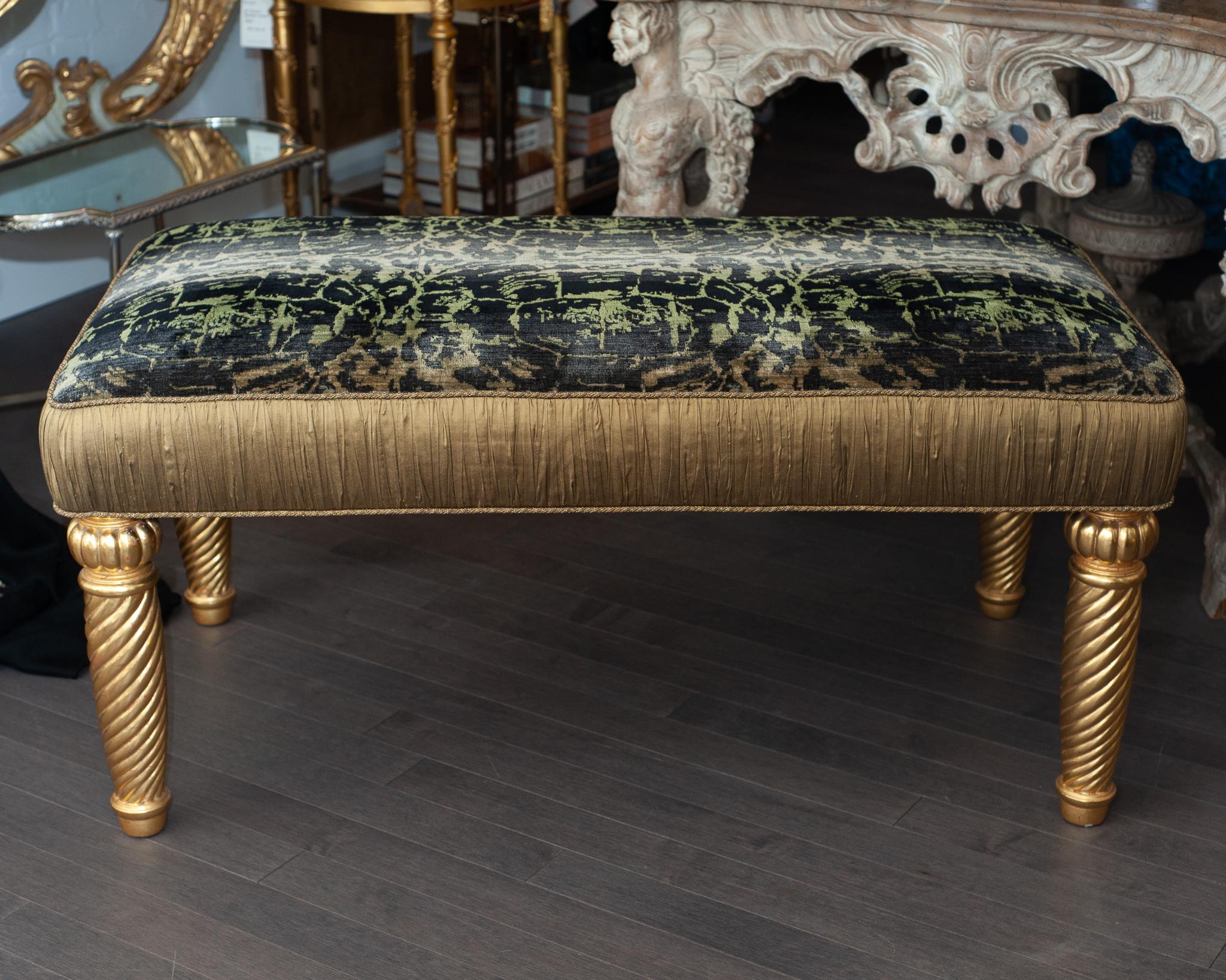 A gilded bench with hand carved barley sugar legs upholstered by our master upholsterer in a unique and rare Bevilacqua tortoise patterned silk velvet, originally produced for a runway fashion show. The sides have been shirred in a bronze silk and