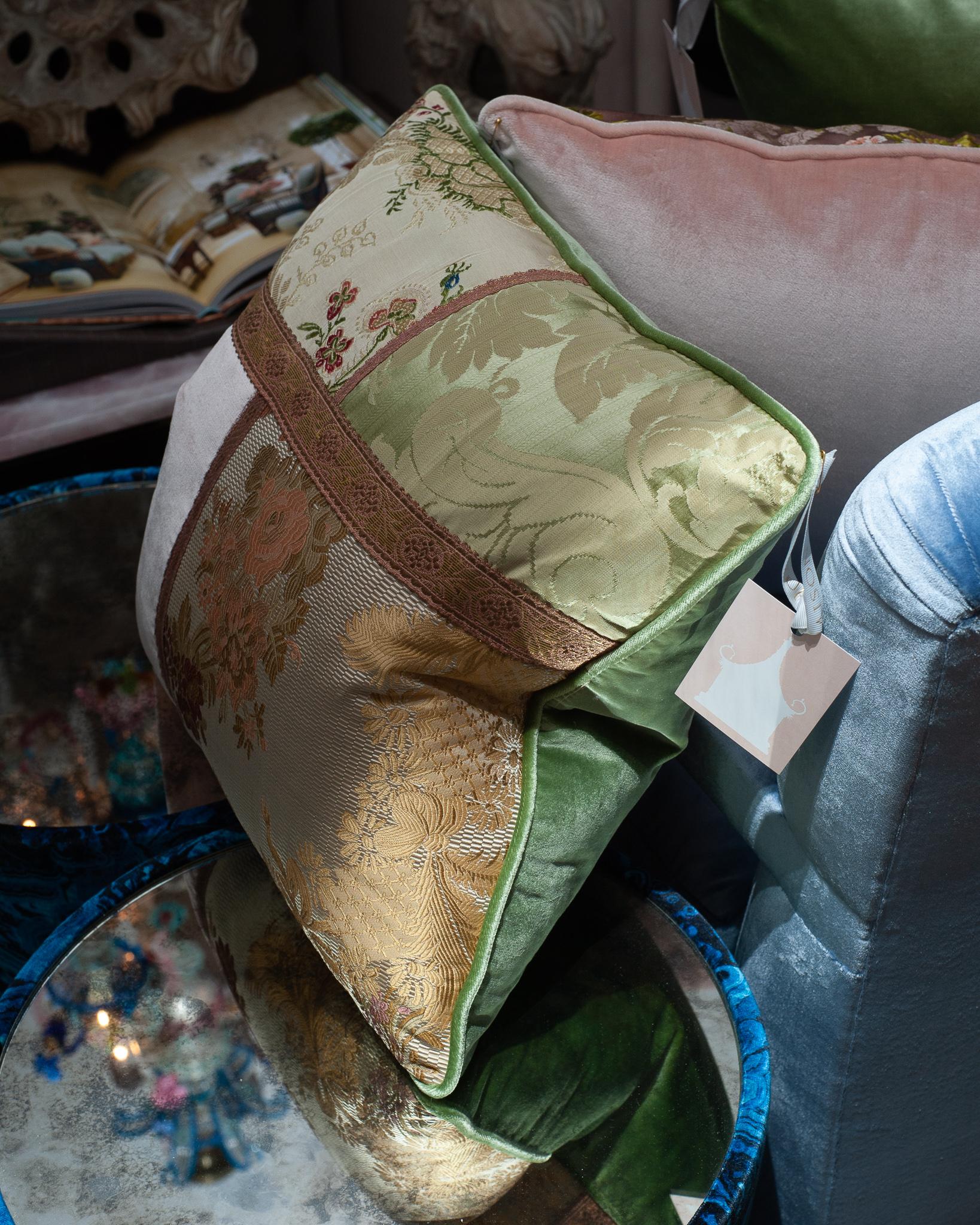 A Studio Maison Nurita handmade patchwork pillow in a variety of floral document prints, pink and green silk velvet, and metallic trims. Filled with Canadian down and feather.