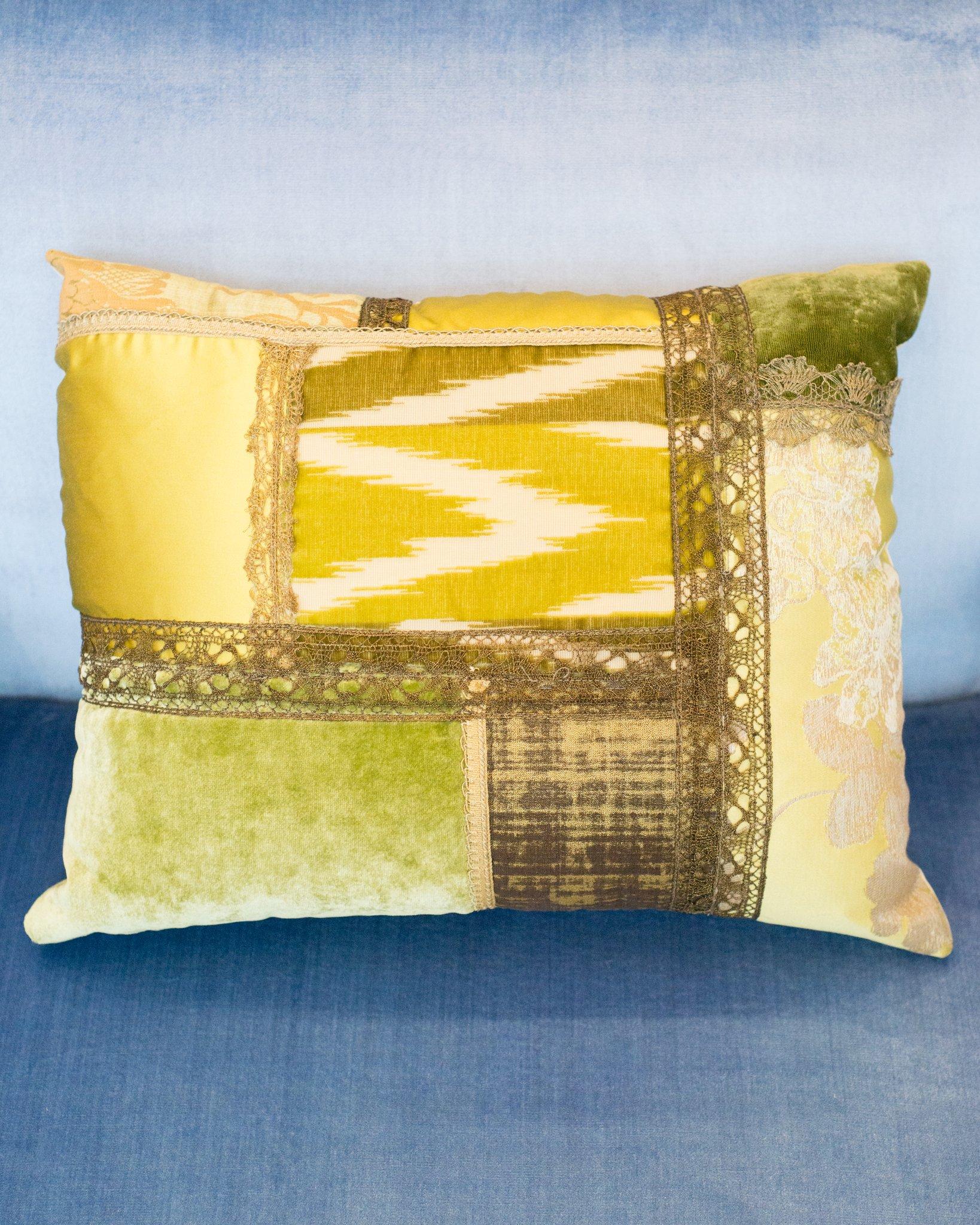 A Studio Maison Nurita handmade patchwork pillow in a variety of green silks and silk velvets with vintage metallic trims, backed in beige silk and down filled.
