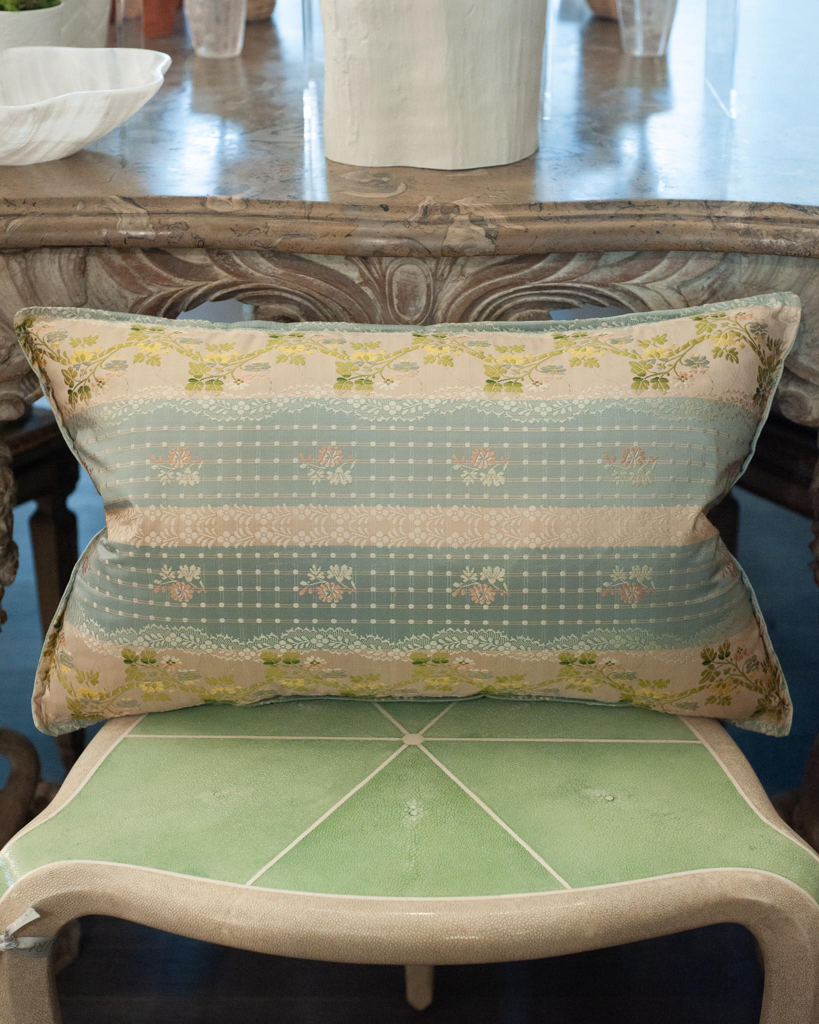 A luxurious Studio Maison Nurita pillow made from a soft blue document print floral brocade, with a tonal soft blue silk back. This pillow is filled with 80/20 Canadian down and feather for a pillow that feels as beautiful as it looks.

