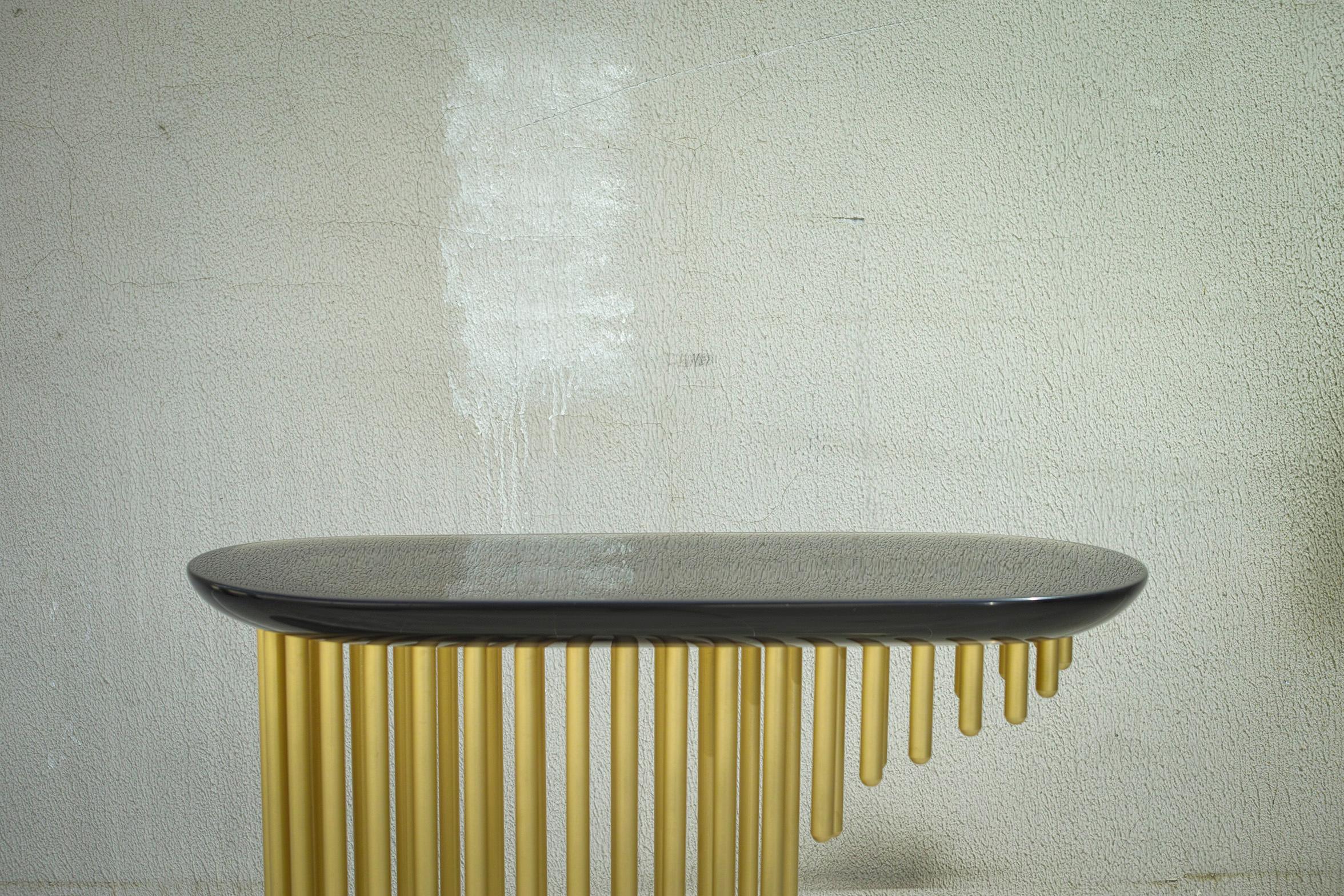 Charleston, Georges Mohasseb Design, 2018
Inspired by the 1920's era and the Art Deco opulent style, this unique console unit is made of refined brushed brass with a matte finish for the base and smoke grey resin cast for the top. This combination