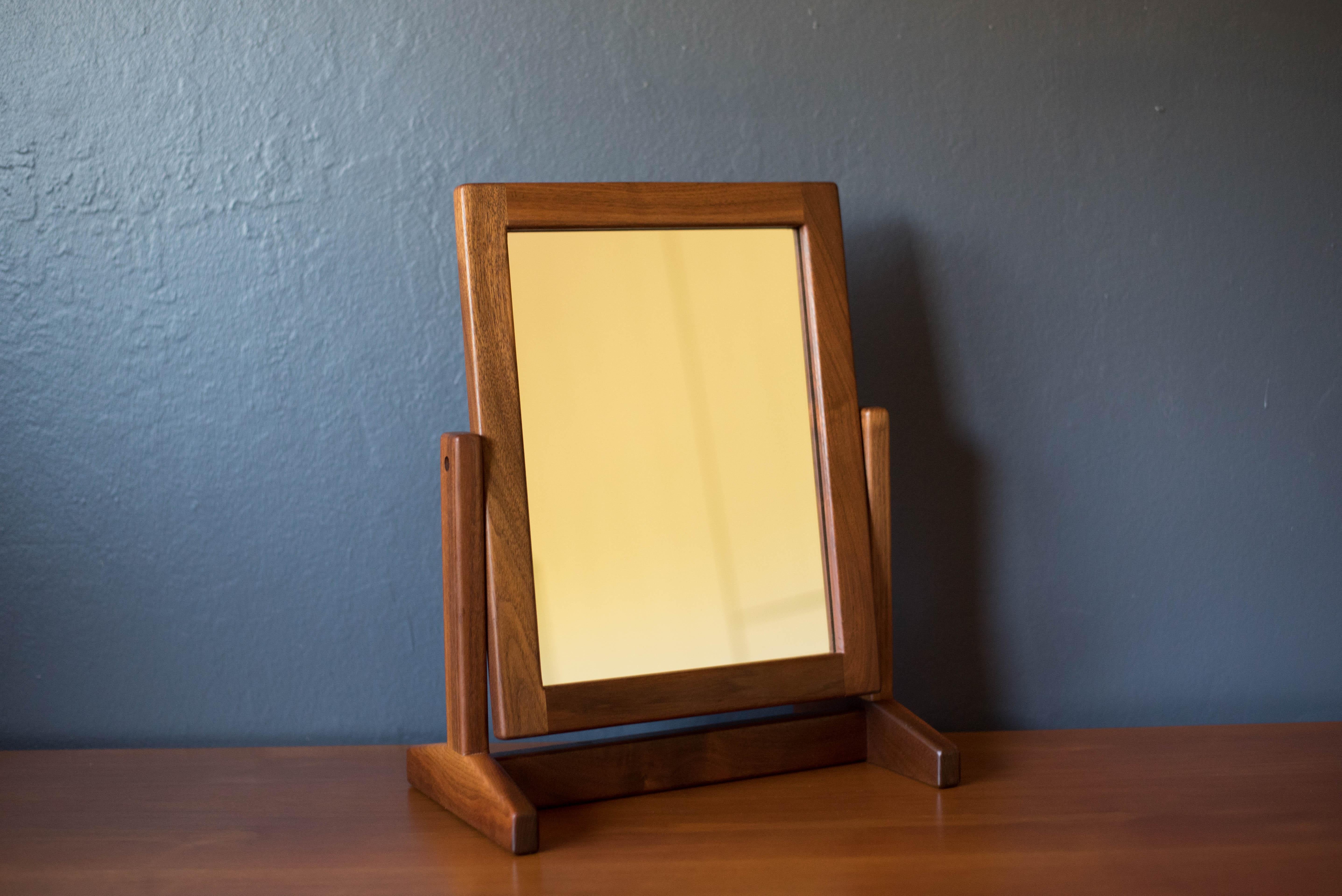 Vintage studio makeup vanity table mirror with stand circa 1960's. This unique pivoting accent mirror is framed in solid walnut wood and is perfect for everyday use in the bathroom, dressing room, or accented on a bedroom dresser. 




Offered by