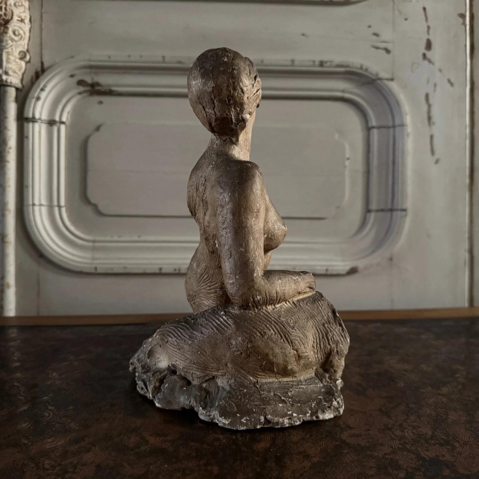 20th Century Studio plaster by Charles Filleul depicting a nude young woman seated on a rock. For Sale