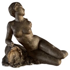 Studio plaster by Charles Filleul depicting a nude young woman seated on a rock.