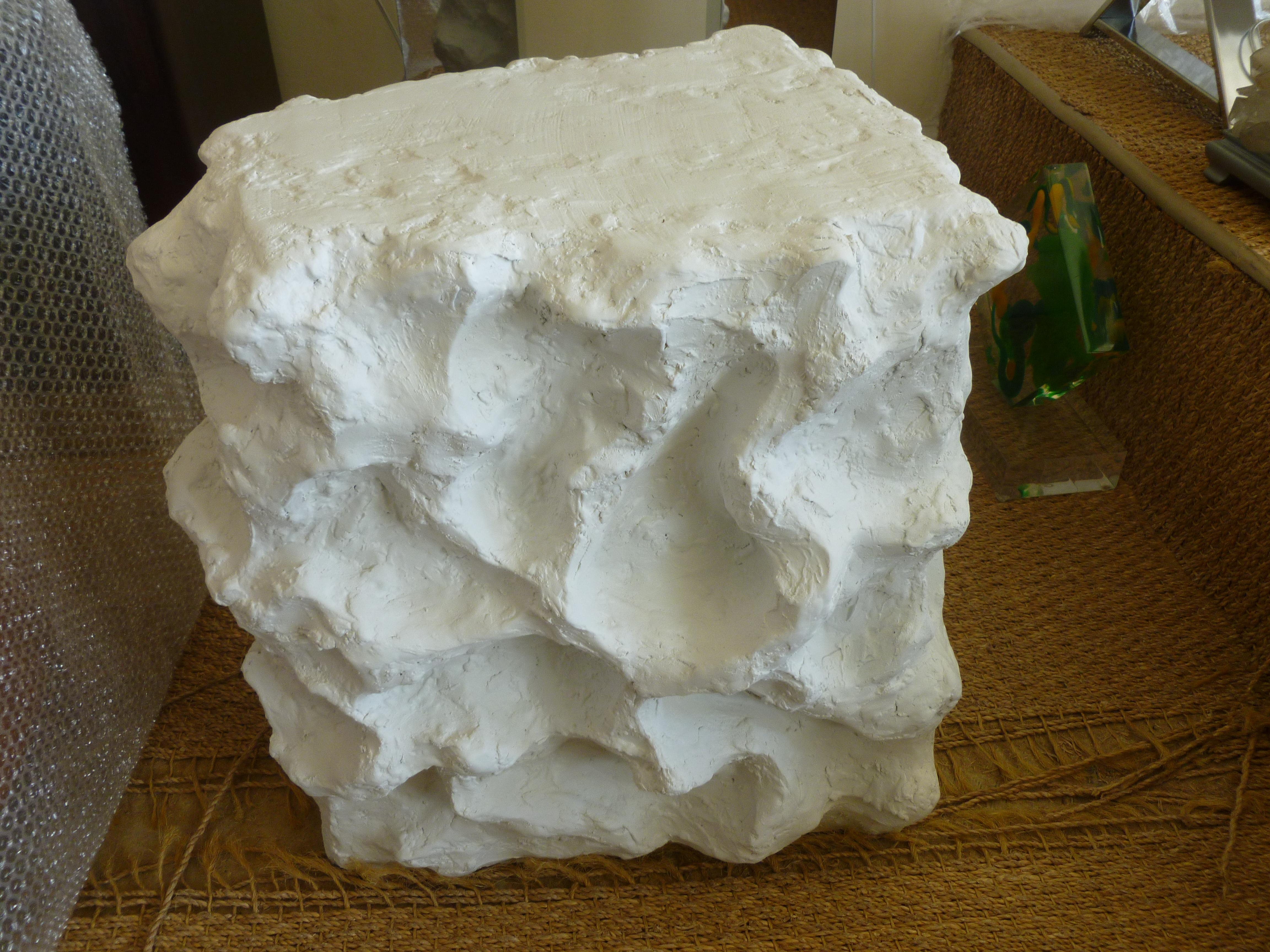 This wonderful studio made white plaster of Paris textural sculptural side table has organic indentations all-over the sides and back. It is artist made and in the style of Sirmos and Serge Roche. It is sculpted like a piece of clay and has a white