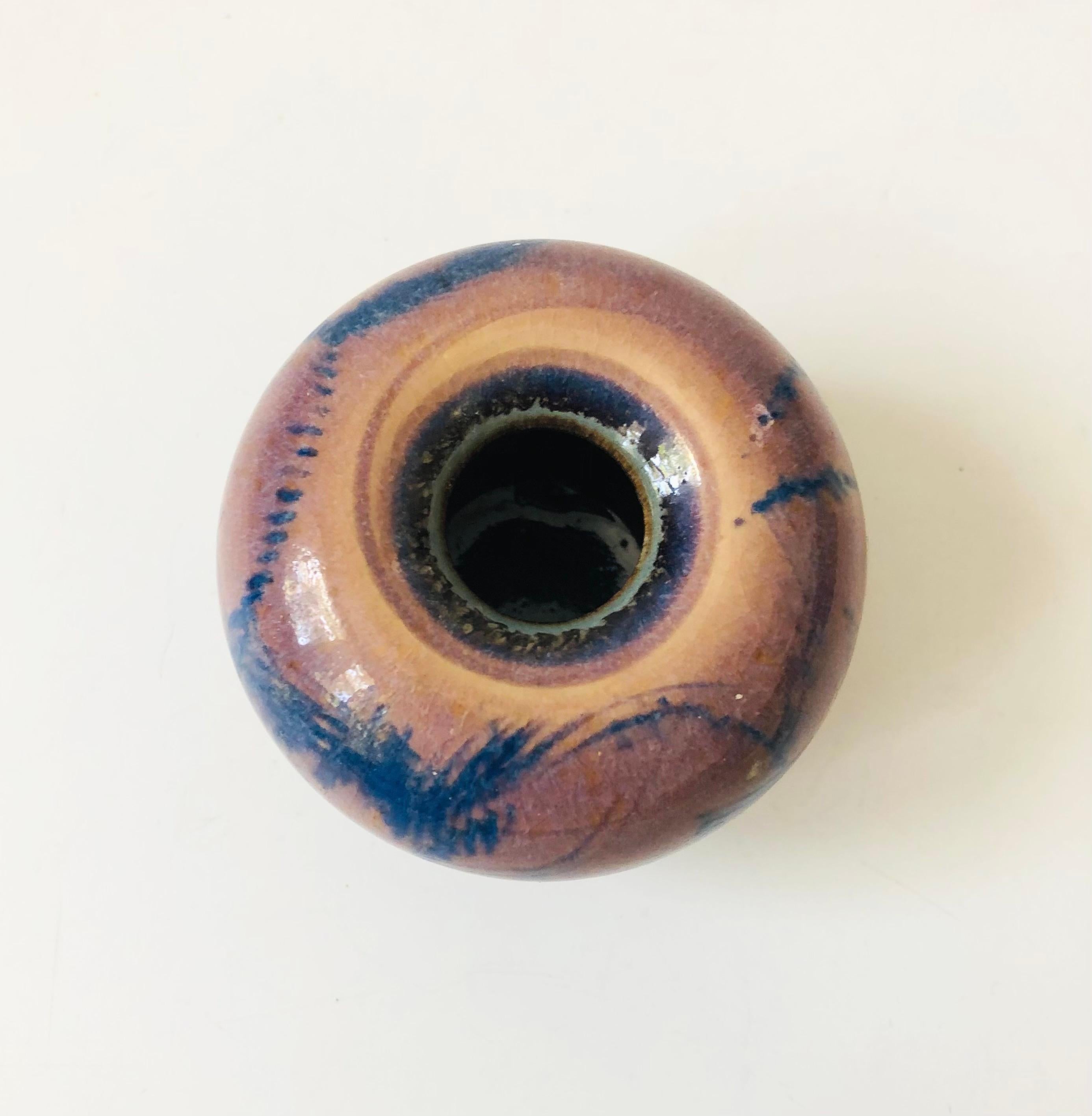 A beautiful wheel thrown studio pottery vase by ceramicist, Barbara Sebastian of Marin, CA. Decorated in purple and blue glazes. Signed on the base.

