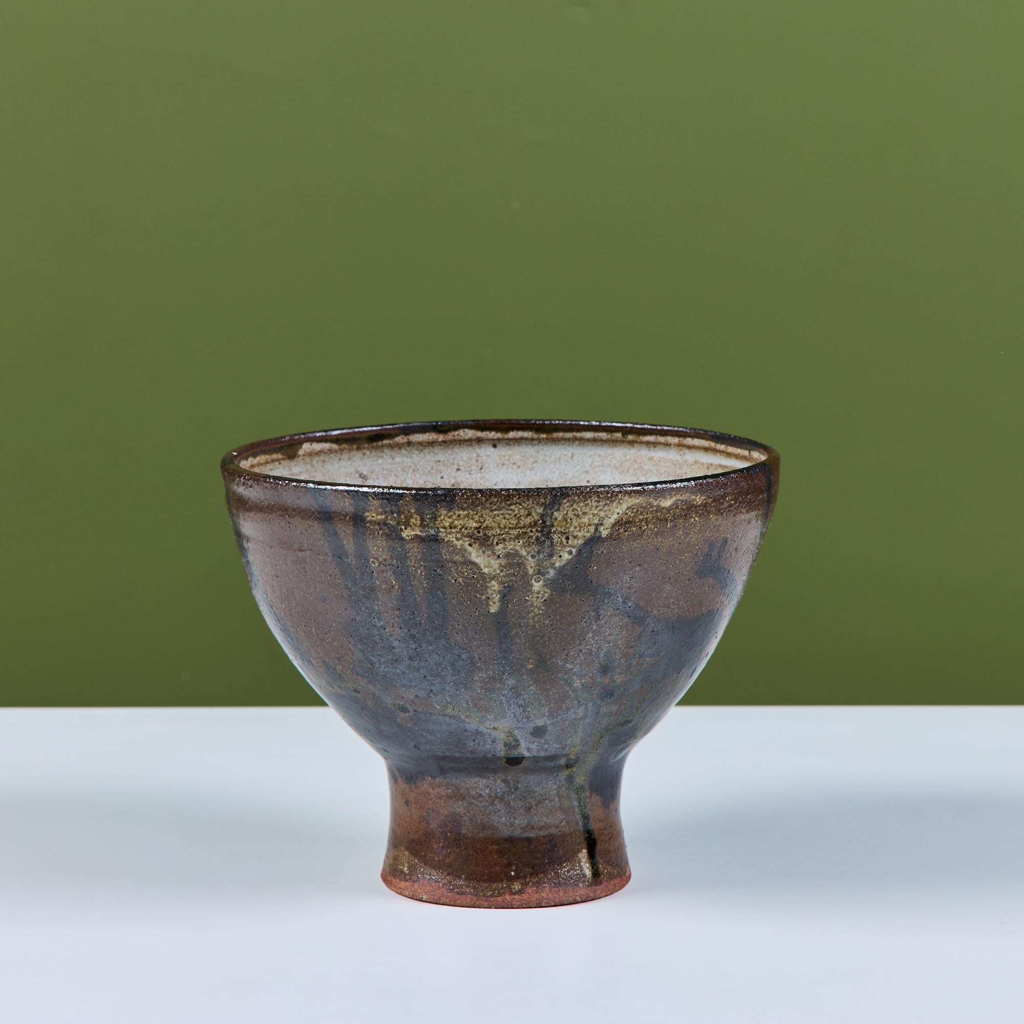 Stoneware chalice bowl with drip glaze. The piece features a pedestal base with a rust and black drip glaze and white speckled interior. Signed by the artist.

Dimensions
9” diameter x 7” height.

Condition
Excellent vintage condition,