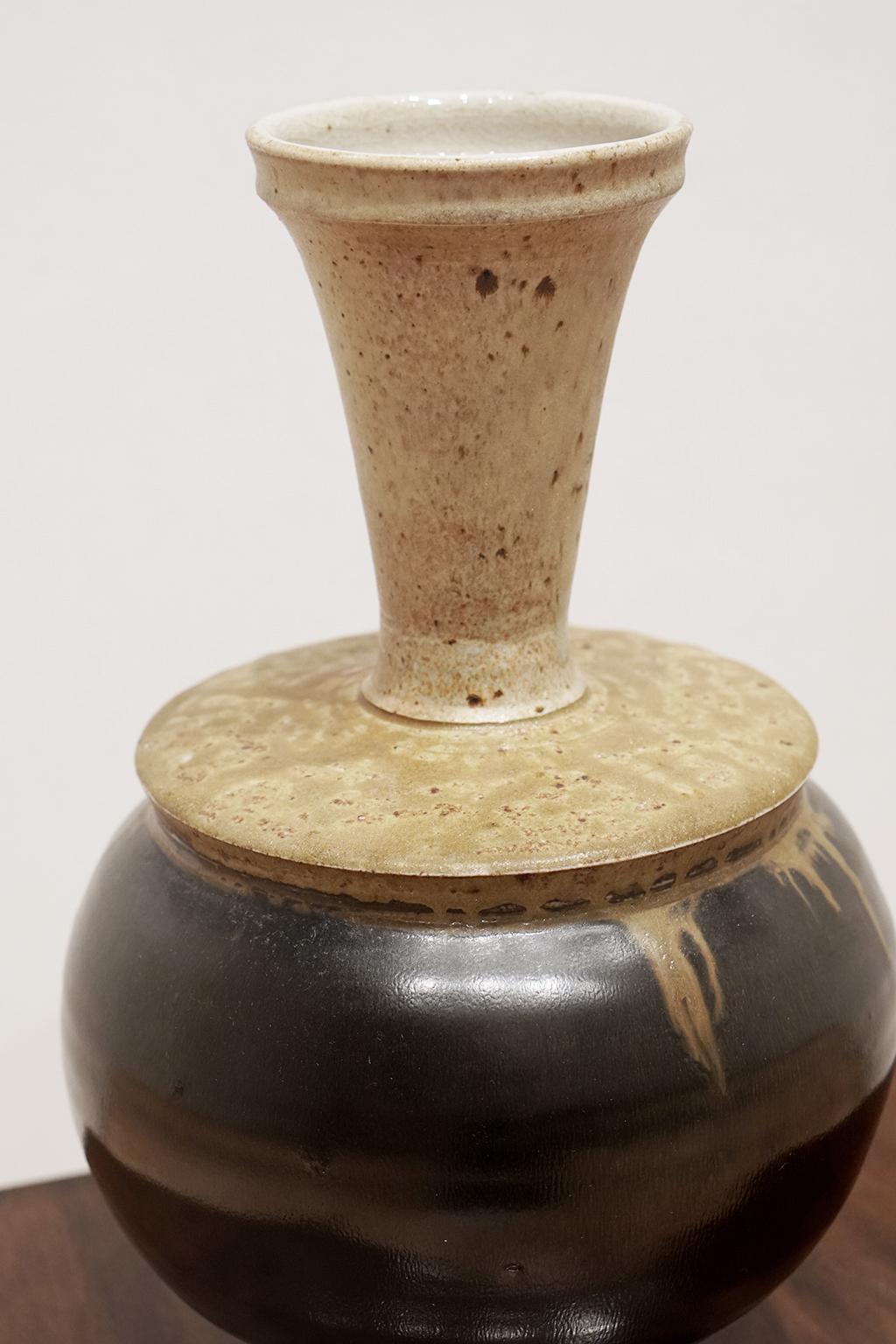 Vintage Studio pottery gourd vase with black glaze body and ochre glazed neck, circa 1970.