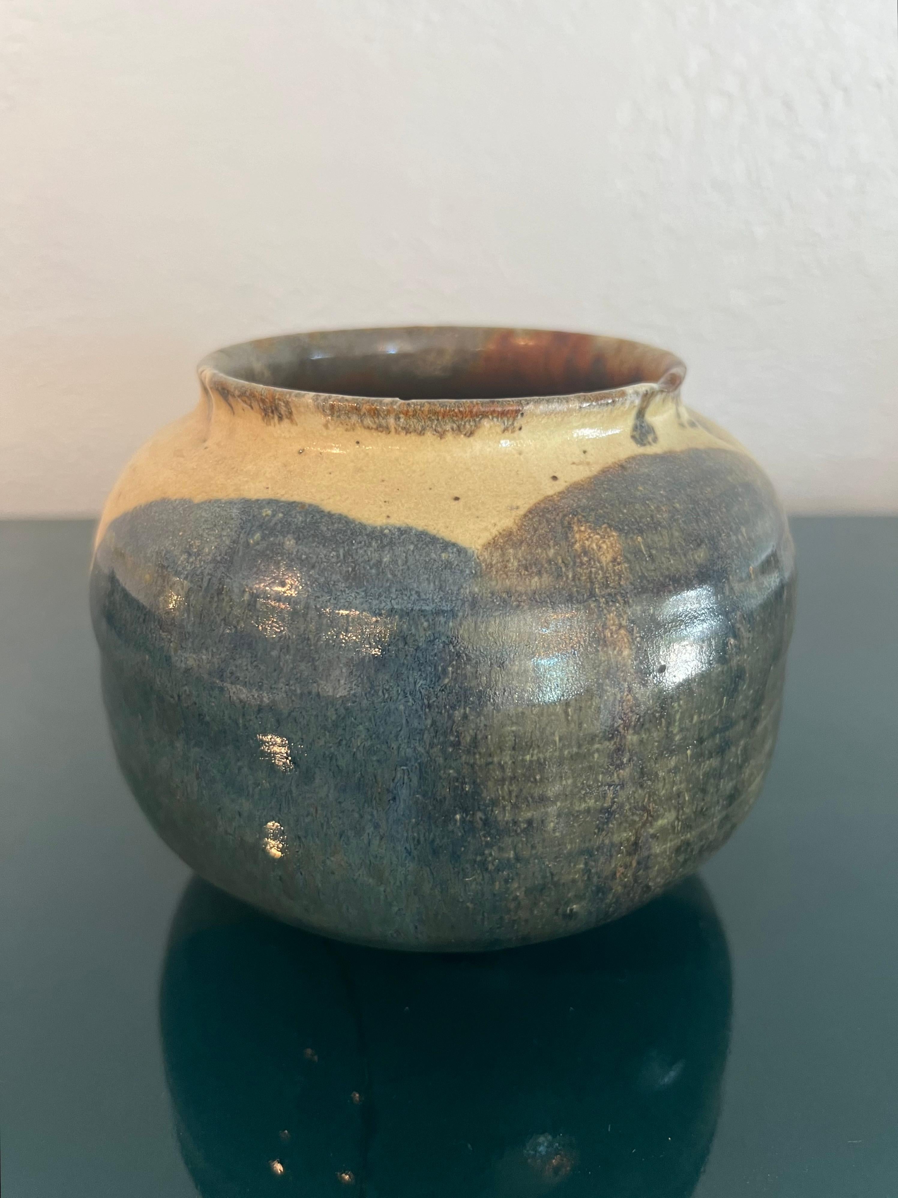 Signed studio pottery glazed pot. Intentional indentation on the rim as it is underneath the glazed finish.

Would work well in a variety of interiors such as modern, mid century modern, Hollywood regency, etc. Piece blends seamlessly with other