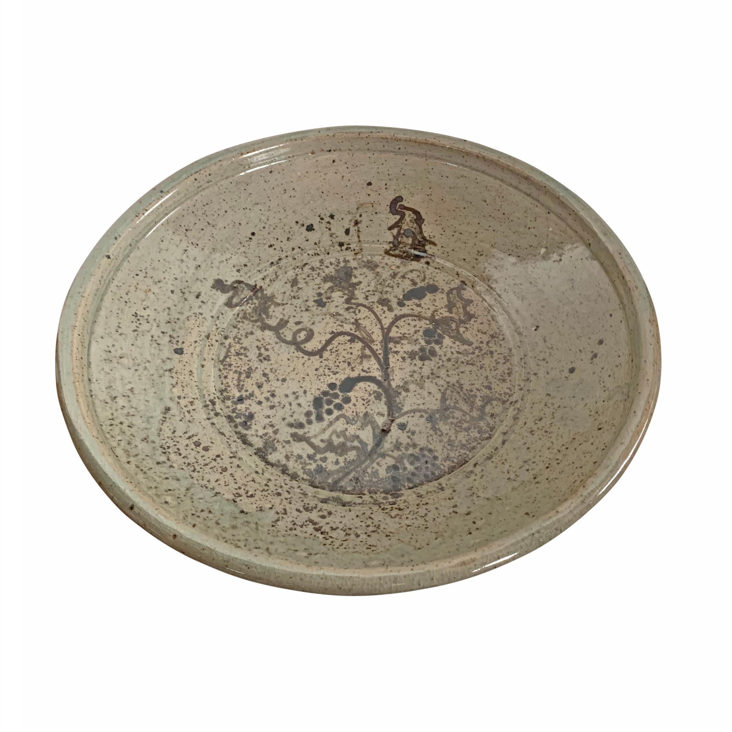 A wonderful late 20th century American Studio Pottery platter with a large stylized grape vine with grape clusters and a wonderful splatter glaze pattern.