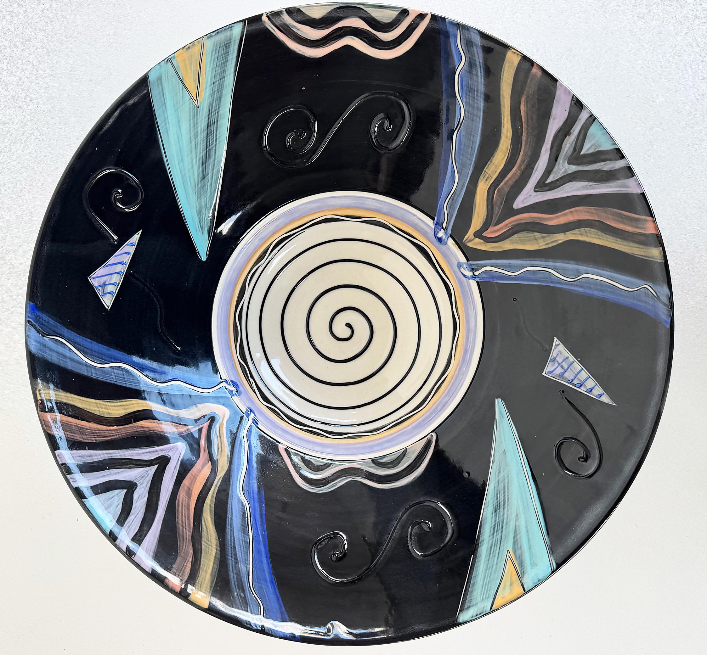 Studio Pottery Post Modern Abstract Centerpiece Bowl 

Offered for sale is a large studio pottery ceramic bowl finished in post-modern designs and colors. 
This oversale bowl has a three section footed base. The underside has a decorated swirl and