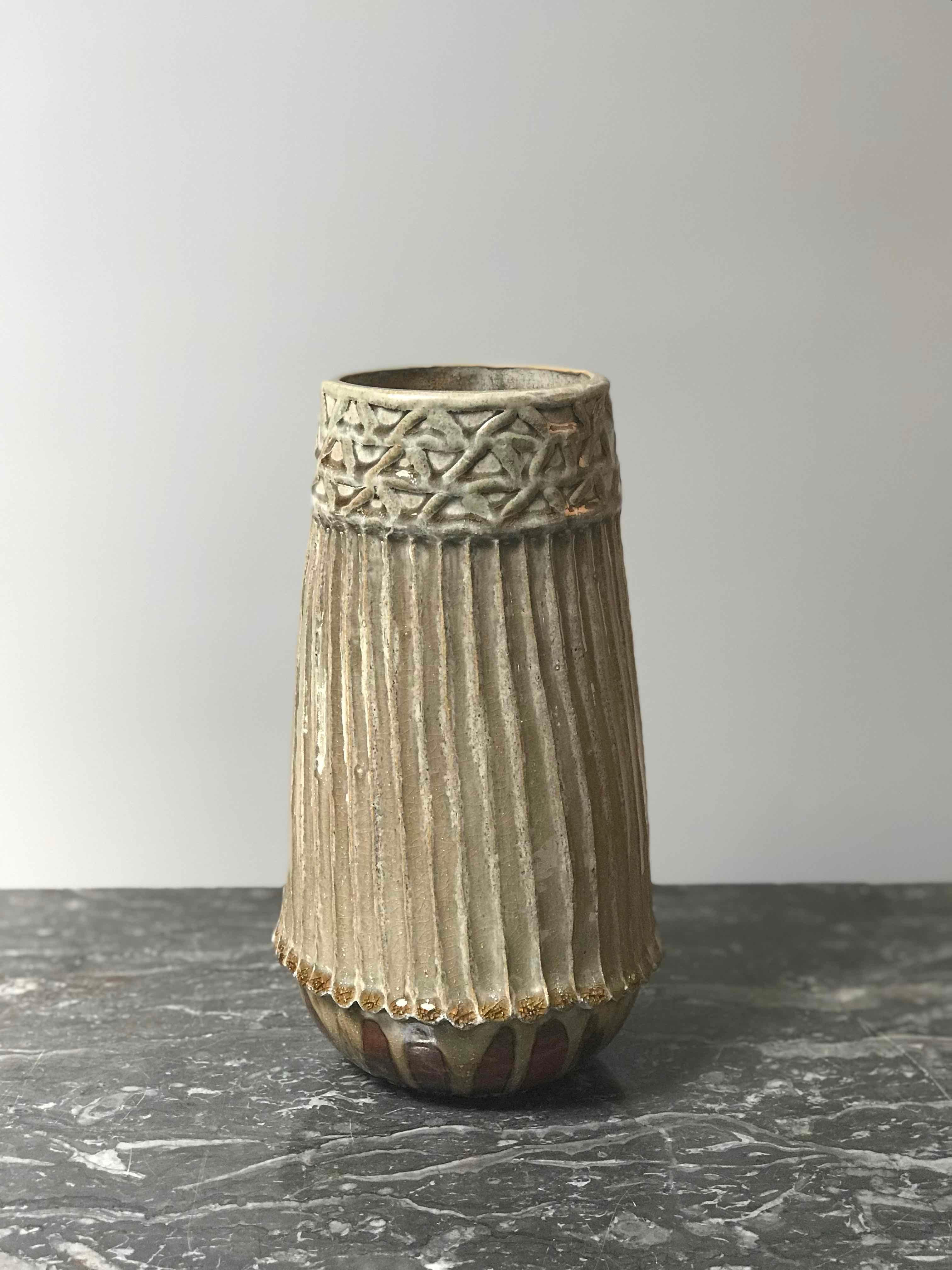 A Studio Pottery ribbed and glazed vase.