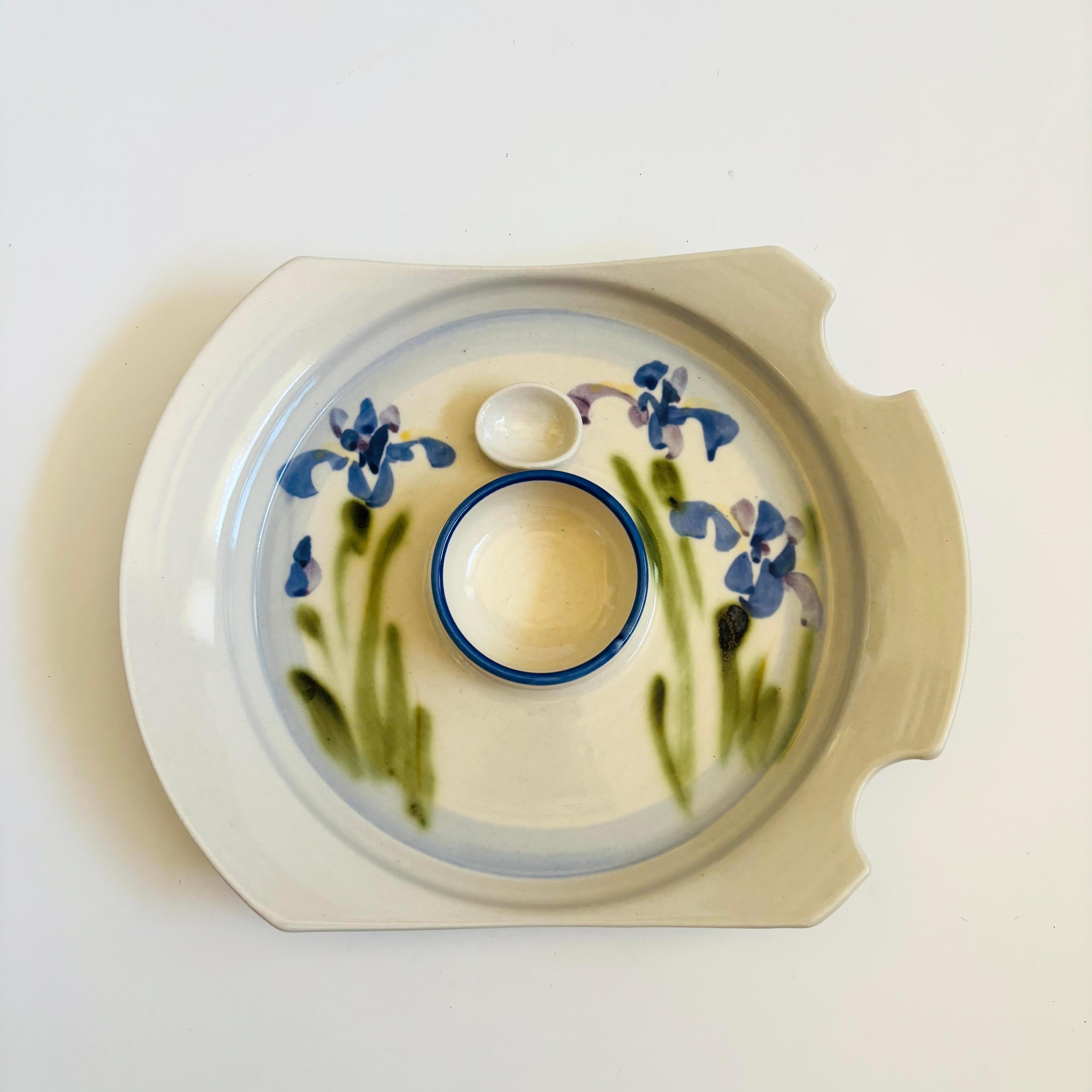 A vintage studio pottery serving plate with a lovely hand painted iris design. There are 2 attached bowls for sauces and grooves have been formed on one side for holding chopsticks. A wonderful and unique serving piece. Signed on the base.

