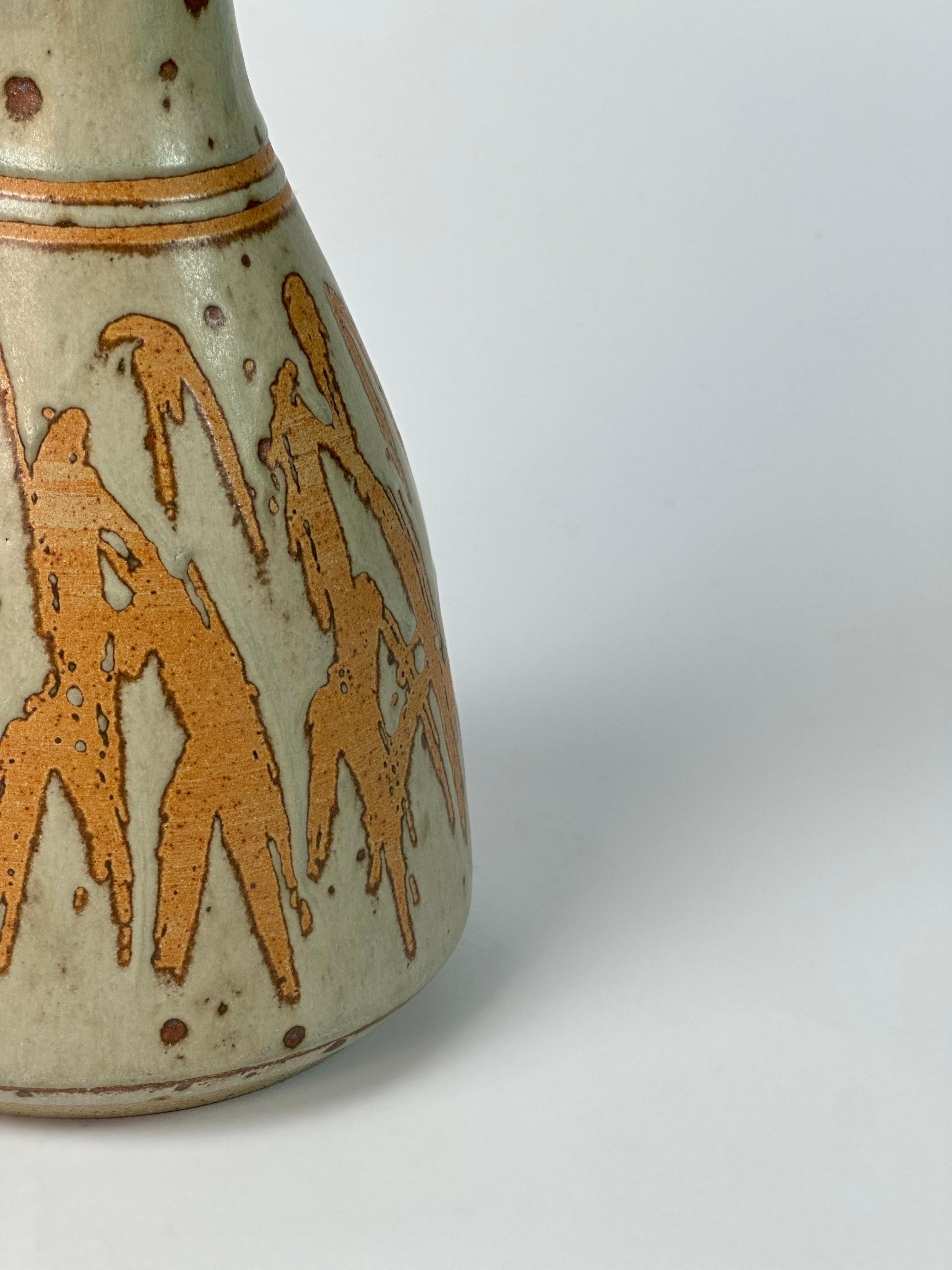 A distinctive example of British studio pottery lighting from the 1980s, this handmade ceramic table lamp was crafted by Graeme James in his Chipping Campden workshop. 

The base combines terracotta and stoneware, executed using the traditional wax