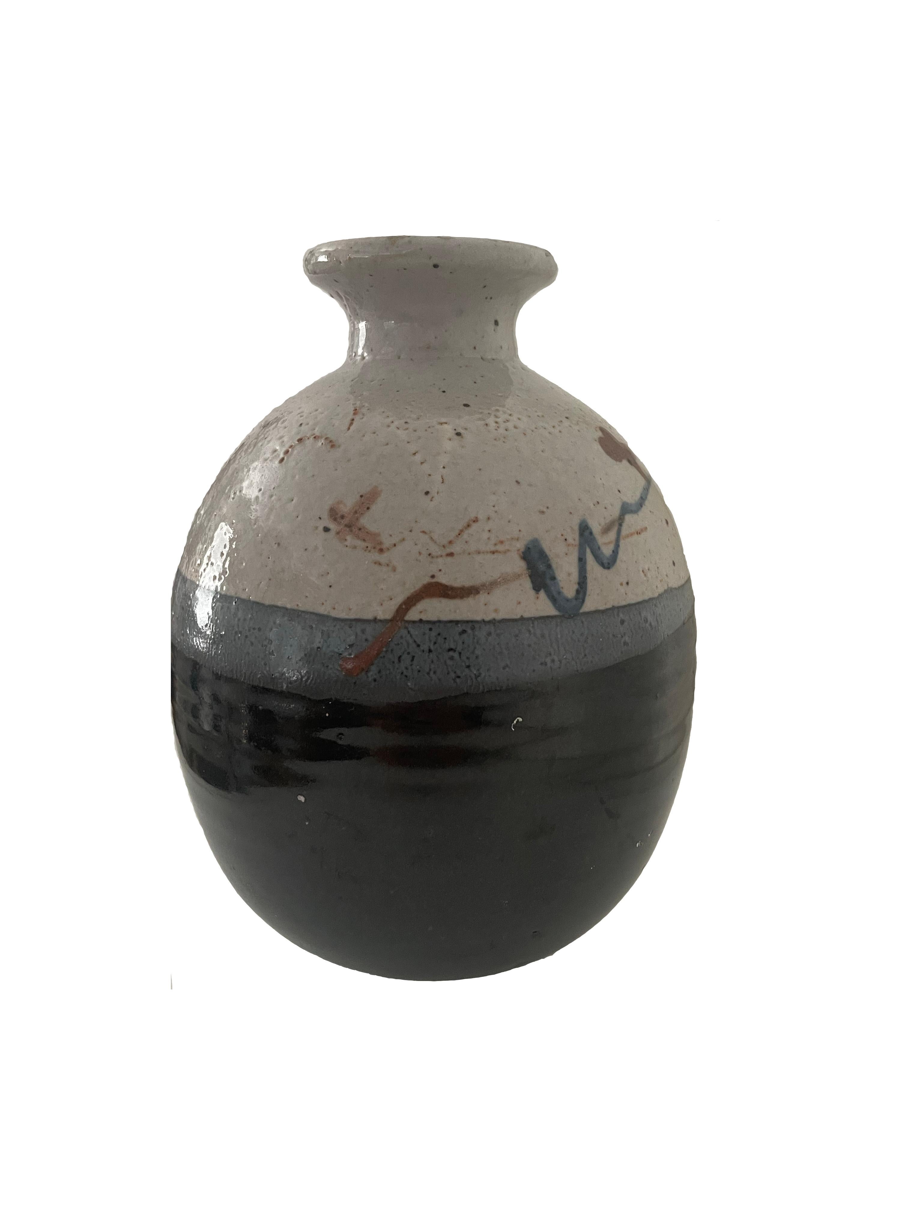 Pottery ash glazed stoneware vase with decorative, hand-painted  brush strokes on upper third of vessel. Dating from the latter 20th century with a narrow, pinched neck and textured surface throughout. Multi-tone glaze in shades of black and light