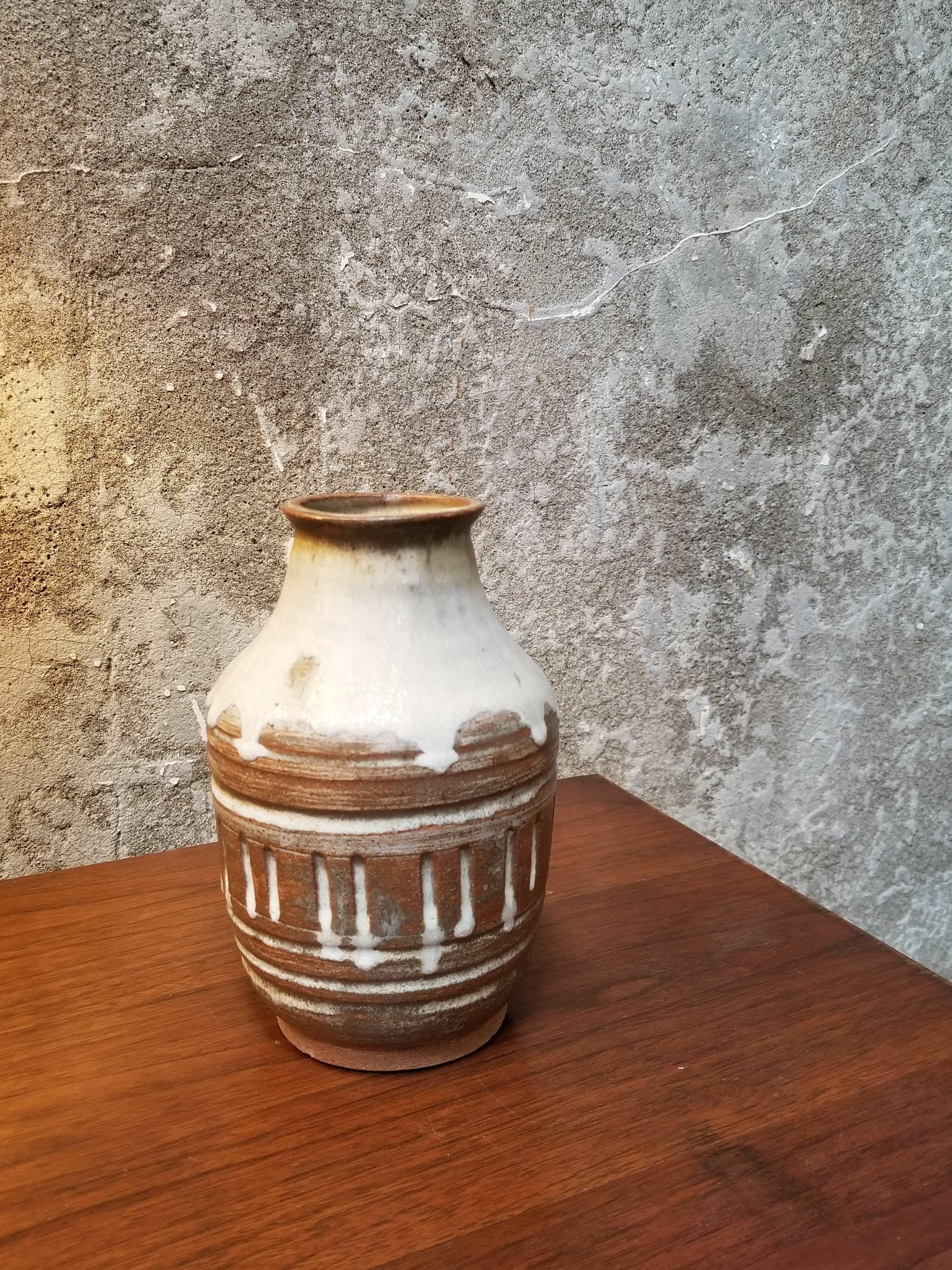 A pottery vase by San Francisco artist Herman Roderick Volz. Incised with drip glaze. Signed on base.
Painter, muralist, lithographer, set designer and ceramist. Formal training at the Art und Gewerbescule in Zurich and the Academy of Fine Arts,