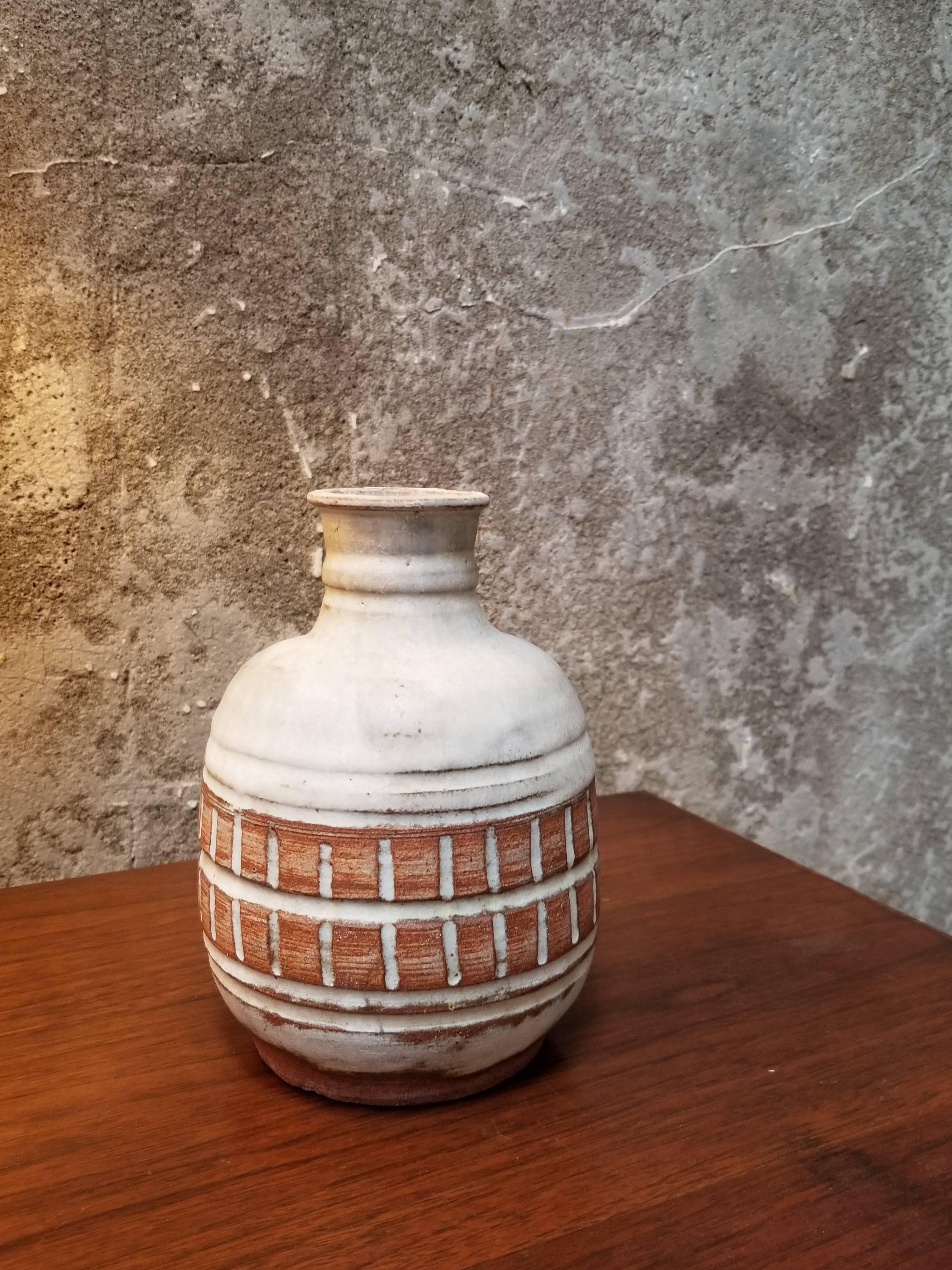 A pottery vase by San Francisco artist Herman Roderick Volz. Incised detail. Signed on base.
Painter, muralist, lithographer, set designer and ceramist. Formal training at the Art und Gewerbescule in Zurich and the Academy of Fine Arts, Vienna.