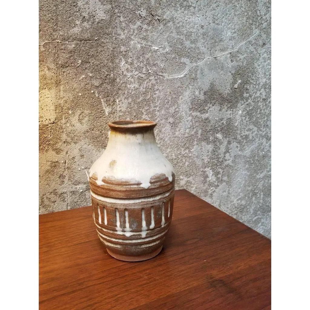 A pottery vase by San Francisco artist Herman Roderick Volz. Incised with drip glaze. Signed on base.
Painter, muralist, lithographer, set designer and ceramist. Formal training at the Art und Gewerbescule in Zurich and the Academy of Fine Arts,