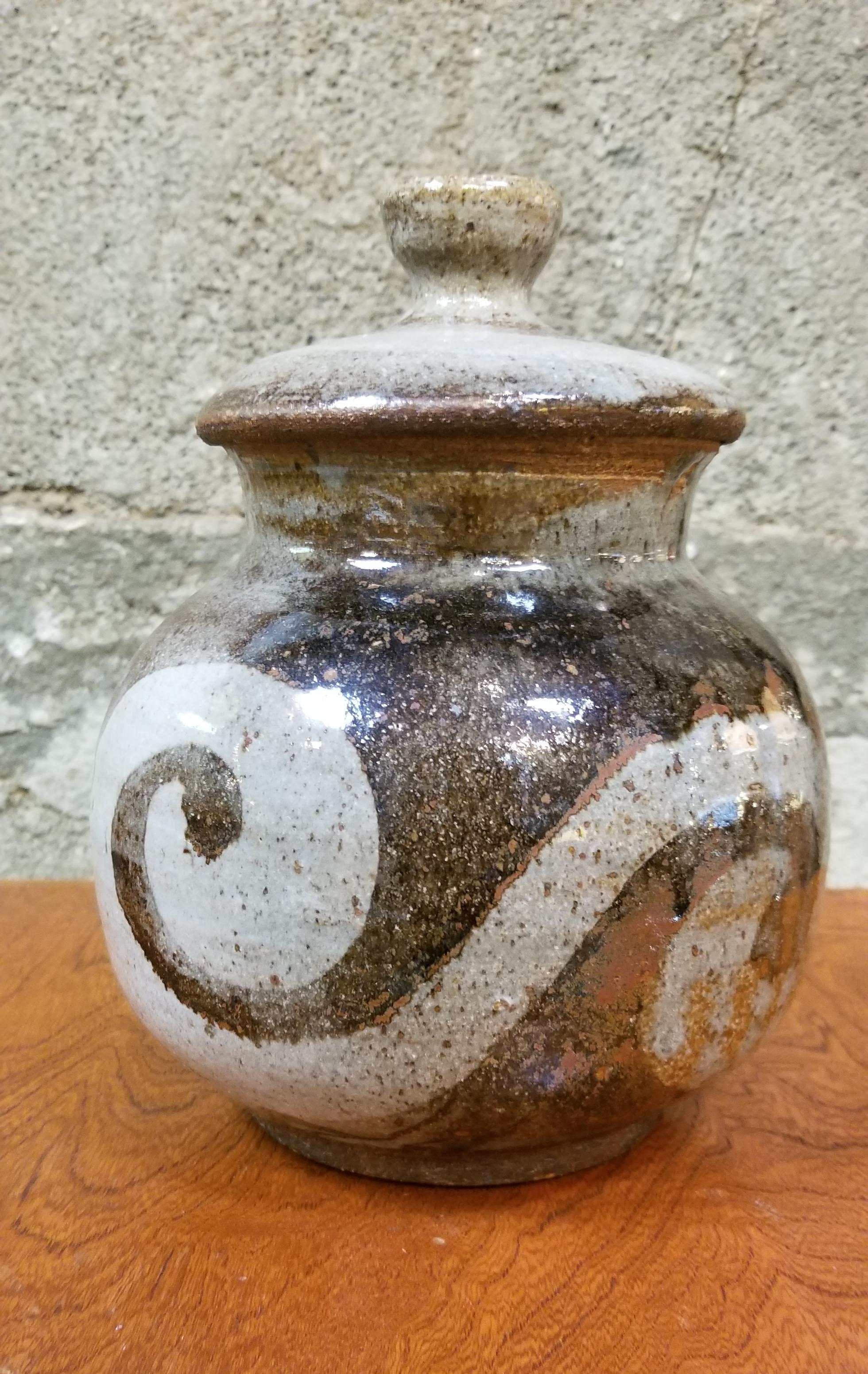 A Mid-Century Modern lidded pottery vase or jar by San Francisco artist Herman Roderick Volz, circa 1970s. Signed on base.
Painter, muralist, lithographer, set designer and ceramist. Formal training at the Art und Gewerbescule in Zurich and the