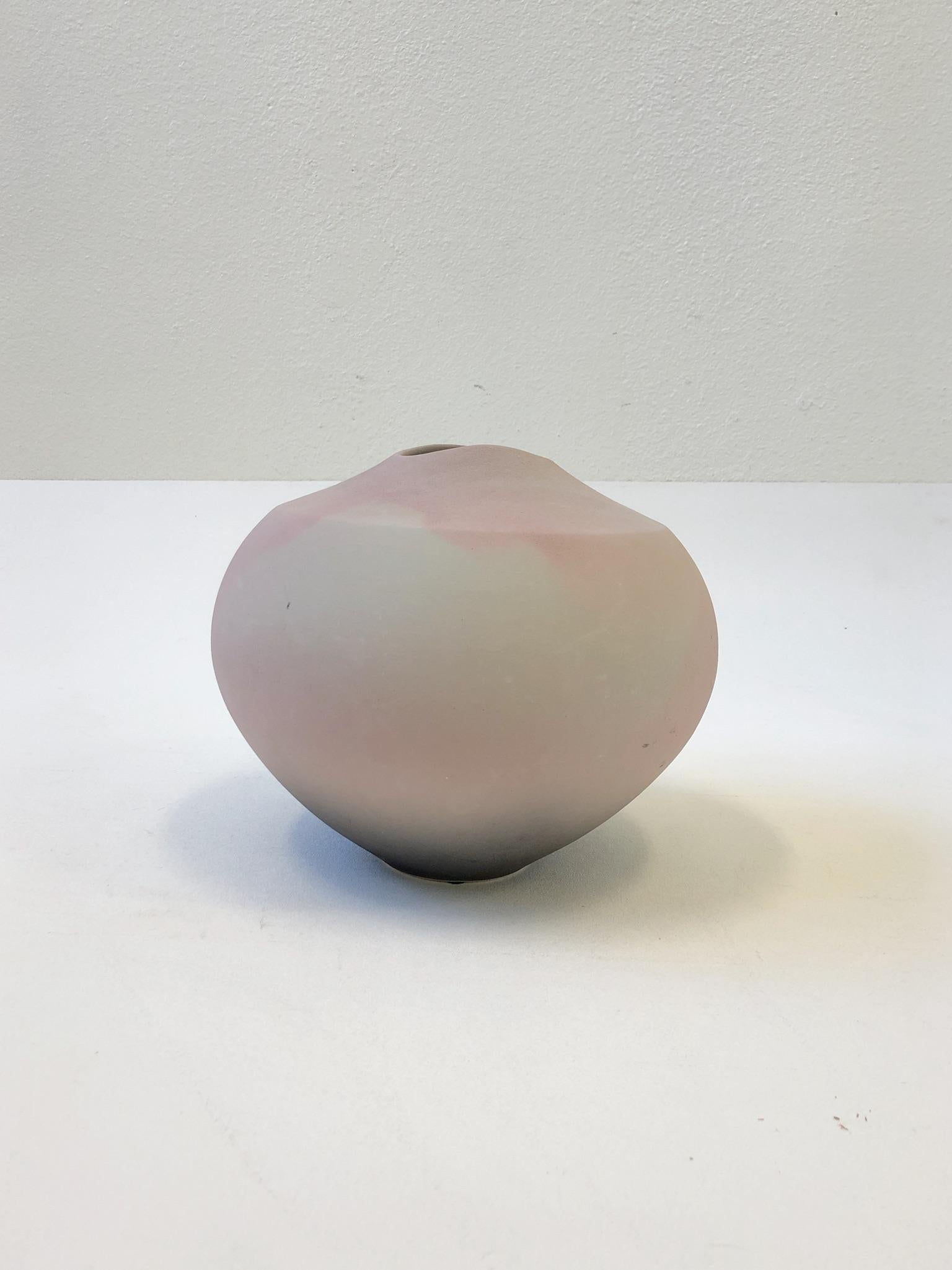A beautiful studio Raku Ovoid pink ceramic vase design in the 1980s by Garry Ubben for Steve Chase. The vase is signed Ubben and retains the Steve Chase label.
Dimension: 11” diameter, 8.75” high.
