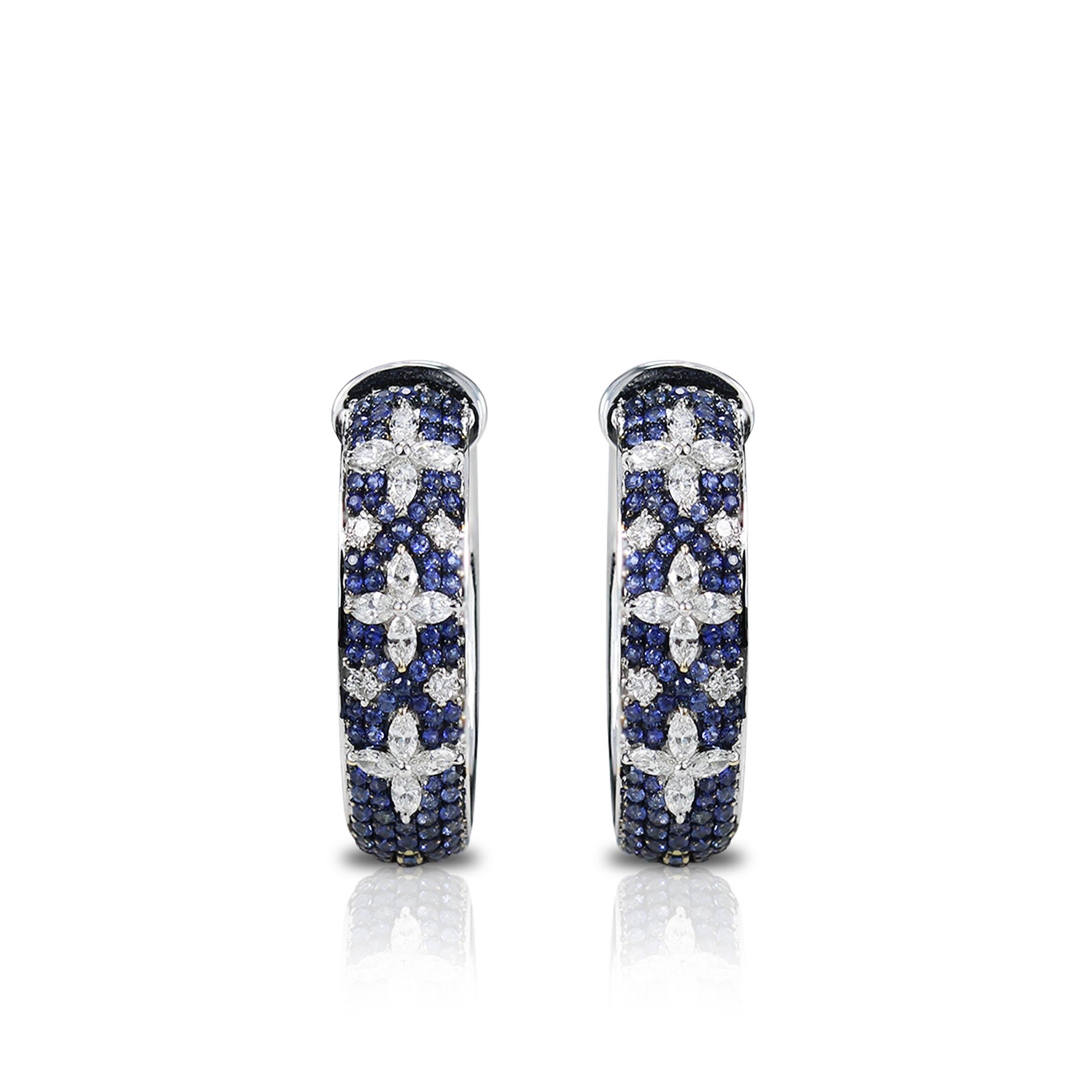 Blue sapphires and Diamonds Hoop Earrings

This 18K white gold hoop earrings created with a bed of blue sapphires, accentuated with twinkling marquise and round diamonds in a prong and pave setting is the kind of everyday staple that is equal parts