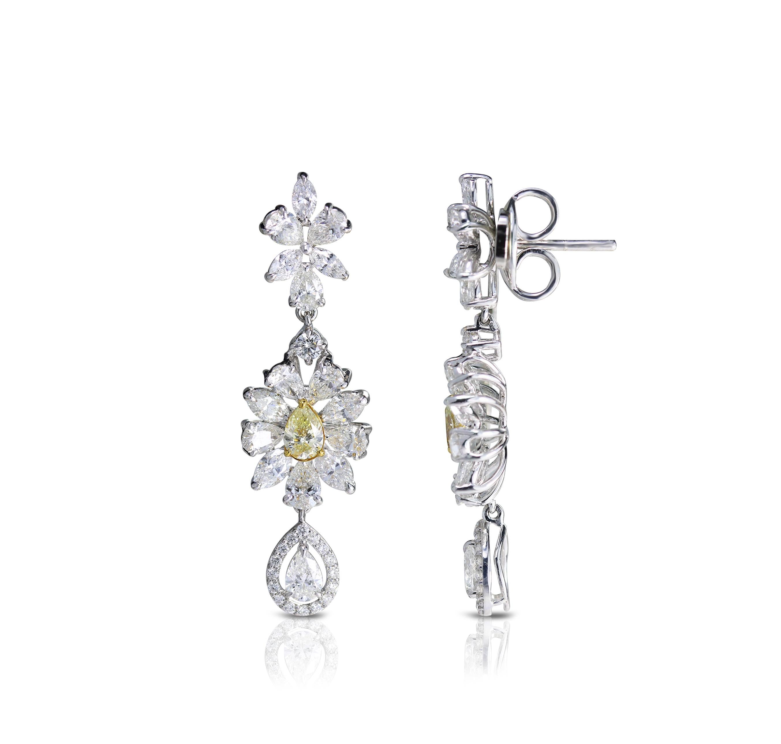 White and yellow diamond danglers

This 18K white and yellow gold danglers studded with marquise, pear and round brilliant cut white and yellow diamonds is high on attention to detailing and supremacy of design. The pair taps into the classic floral
