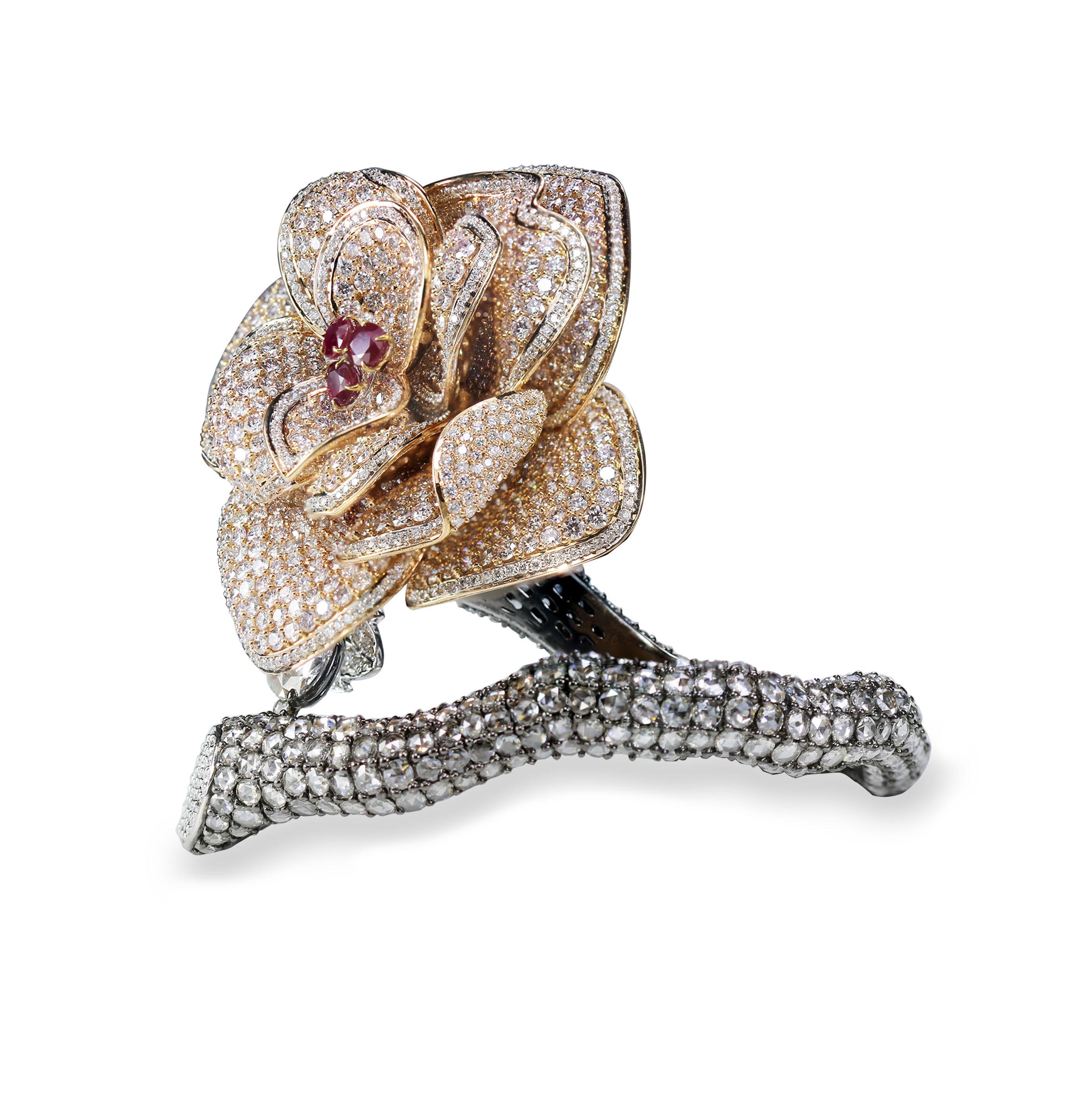 Brilliant cut and rosecut diamonds and ruby floral cuff

We reinvent the classic floral motif with this rose-inspired statement cuff that is a dialogue between handpicked brilliant cut and rosecut diamonds VS-SI quality in an interplay of pavé and