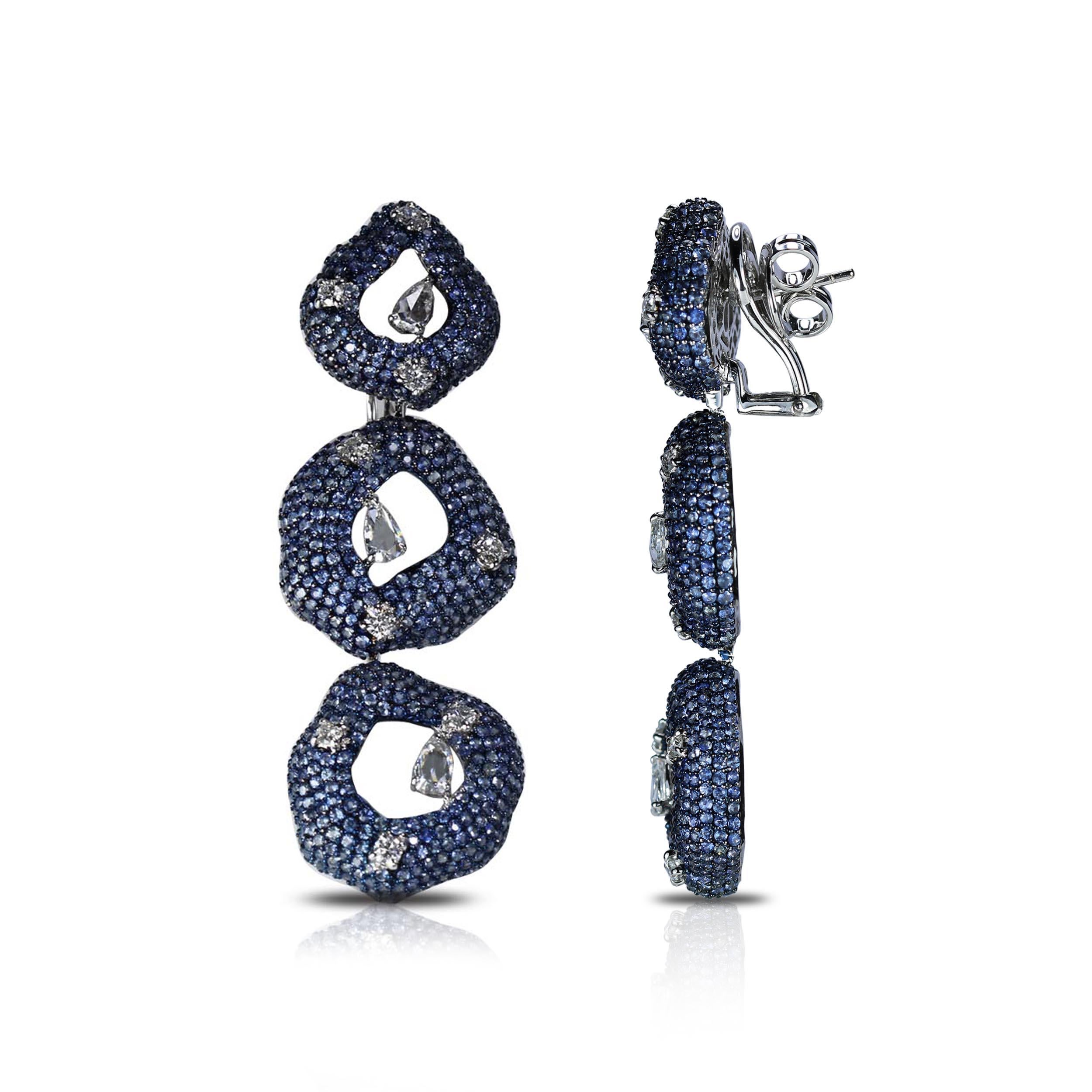 F-G/ VS Diamond and Blue Sapphire Earrings

The sheer innovativeness of this pair makes it nothing short of a piece of art. An army of blue sapphires studded in tiered anti-geometrical circles, further elevated with pear rose cut and round brilliant