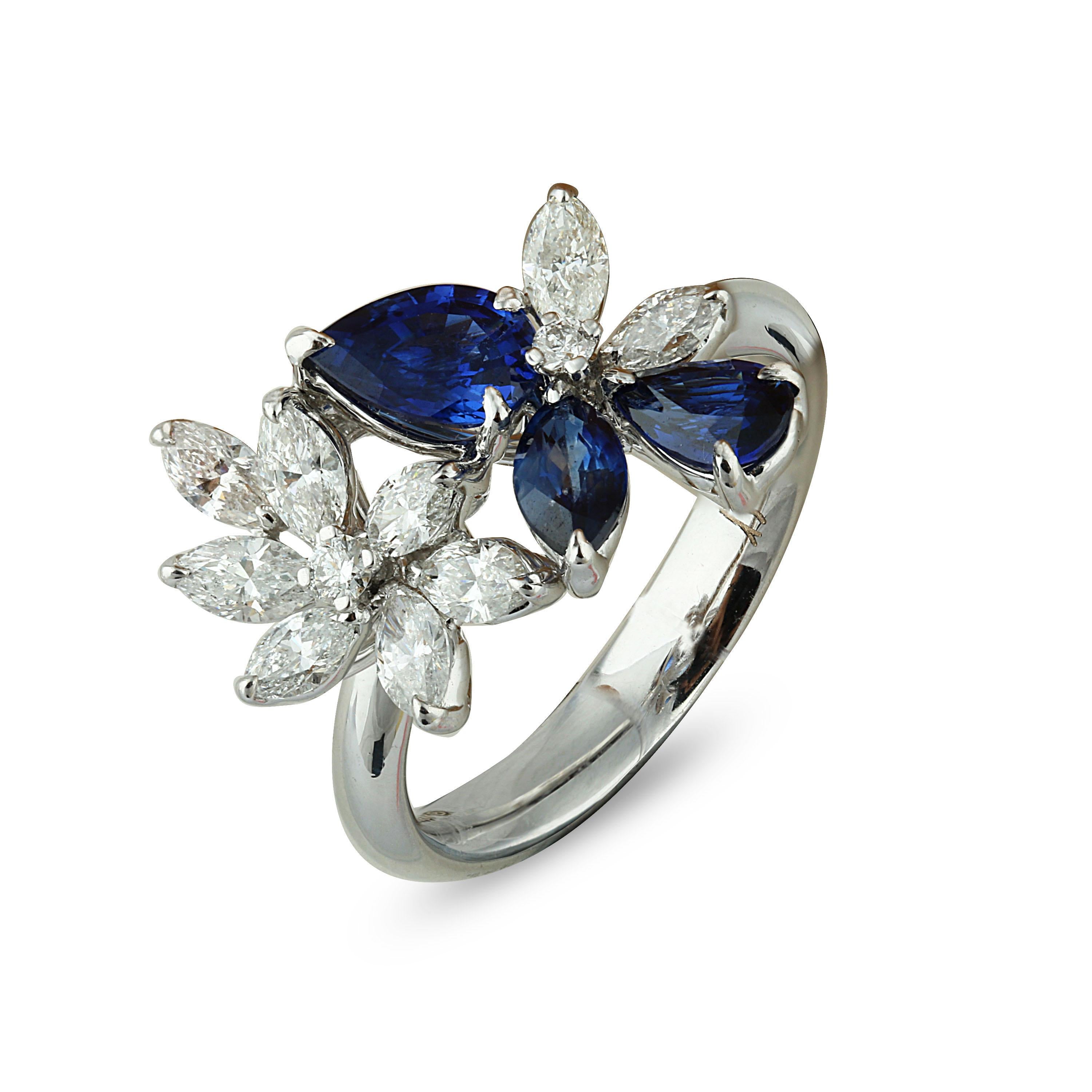 Blue Sapphire and Diamond Ring

Dual floral motifs coupled with dual coloured stones is what lends this exquisite 18K white gold ring it's charismatic flair. Crafted using pear and marquise blue sapphires, and marquise brilliant and round brilliant