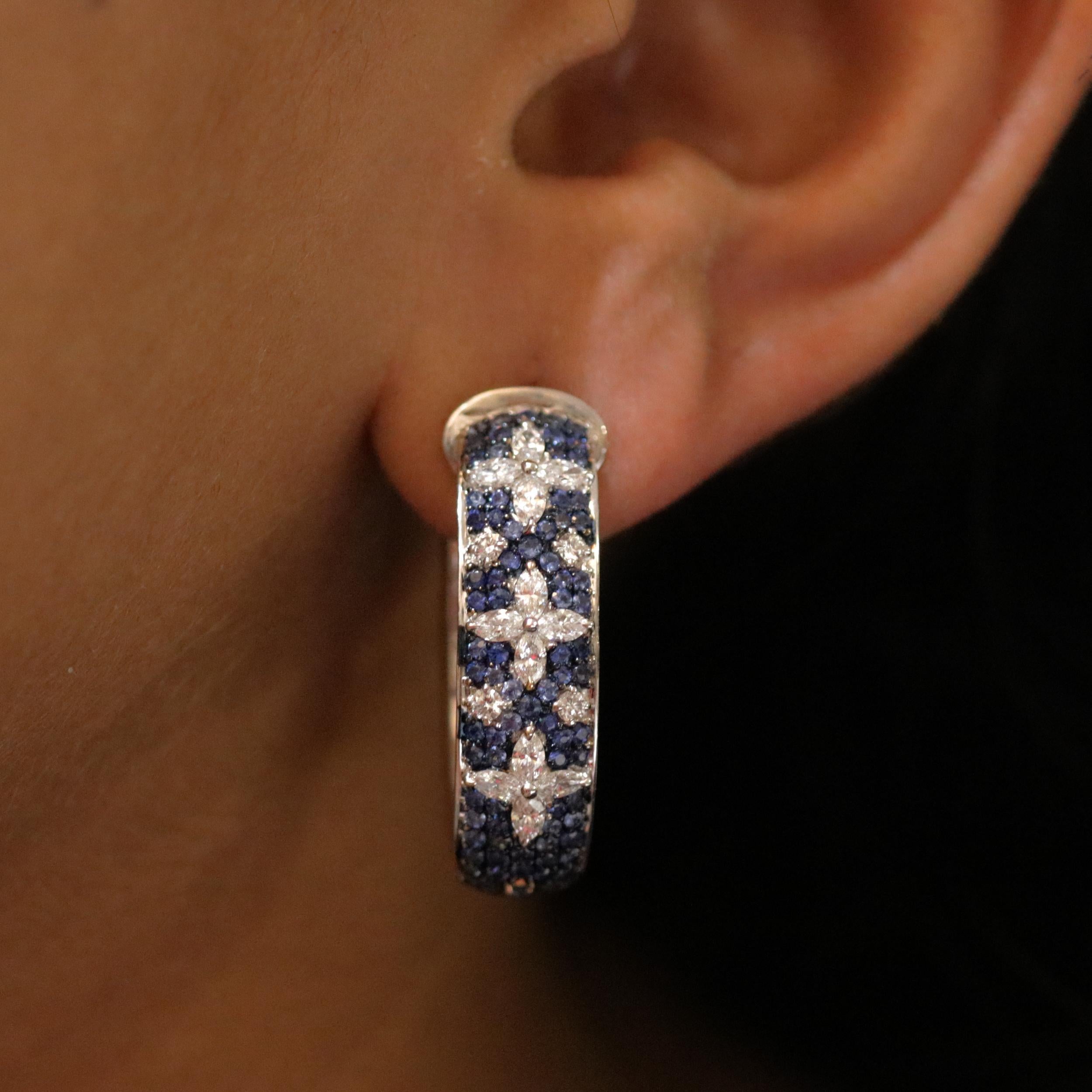 Gross Weight: 17.88 Grams
Diamond Weight: 2.20 cts
Blue Sapphire Weight: 4.56 cts
IGI Certificate: 31J857351810

Video of the product can be shared on request.

This 18K white gold hoop earrings created with a bed of blue sapphires, accentuated with