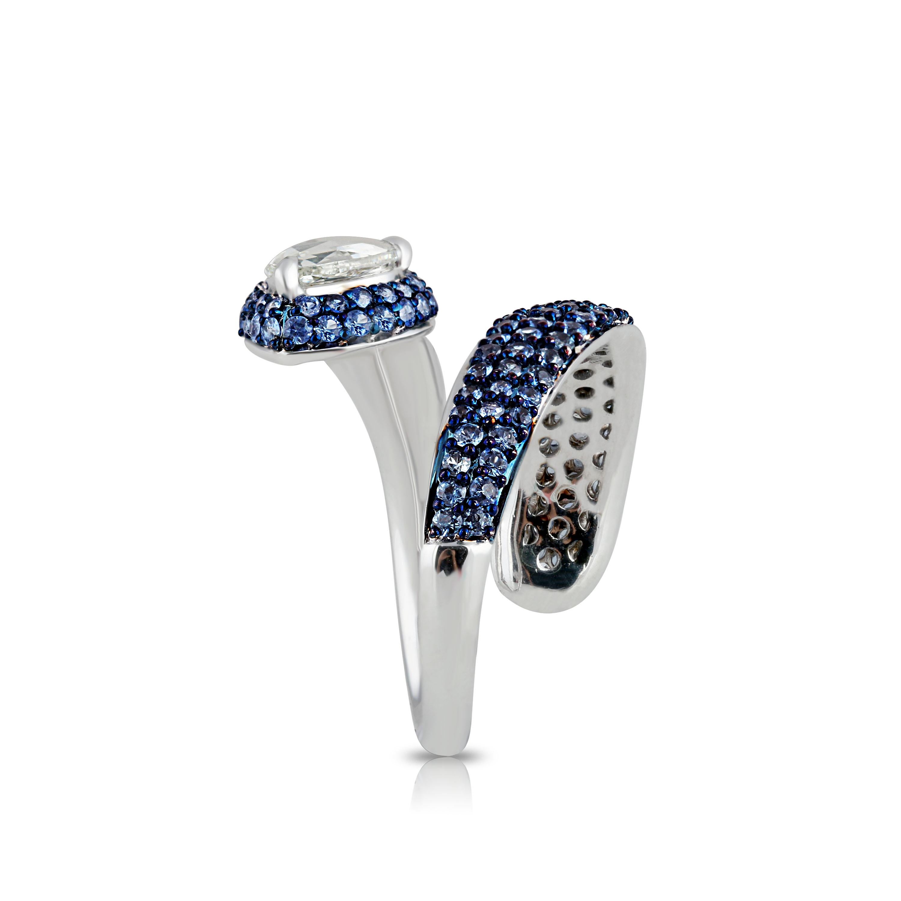 Drawing inspiration from the serpent is this modern-day 18K white gold ring studded with a pear rose cut diamond and blue sapphires in prong and pavé settings. Its elegant design symbolizes the continuity of life with its intricately placed 152