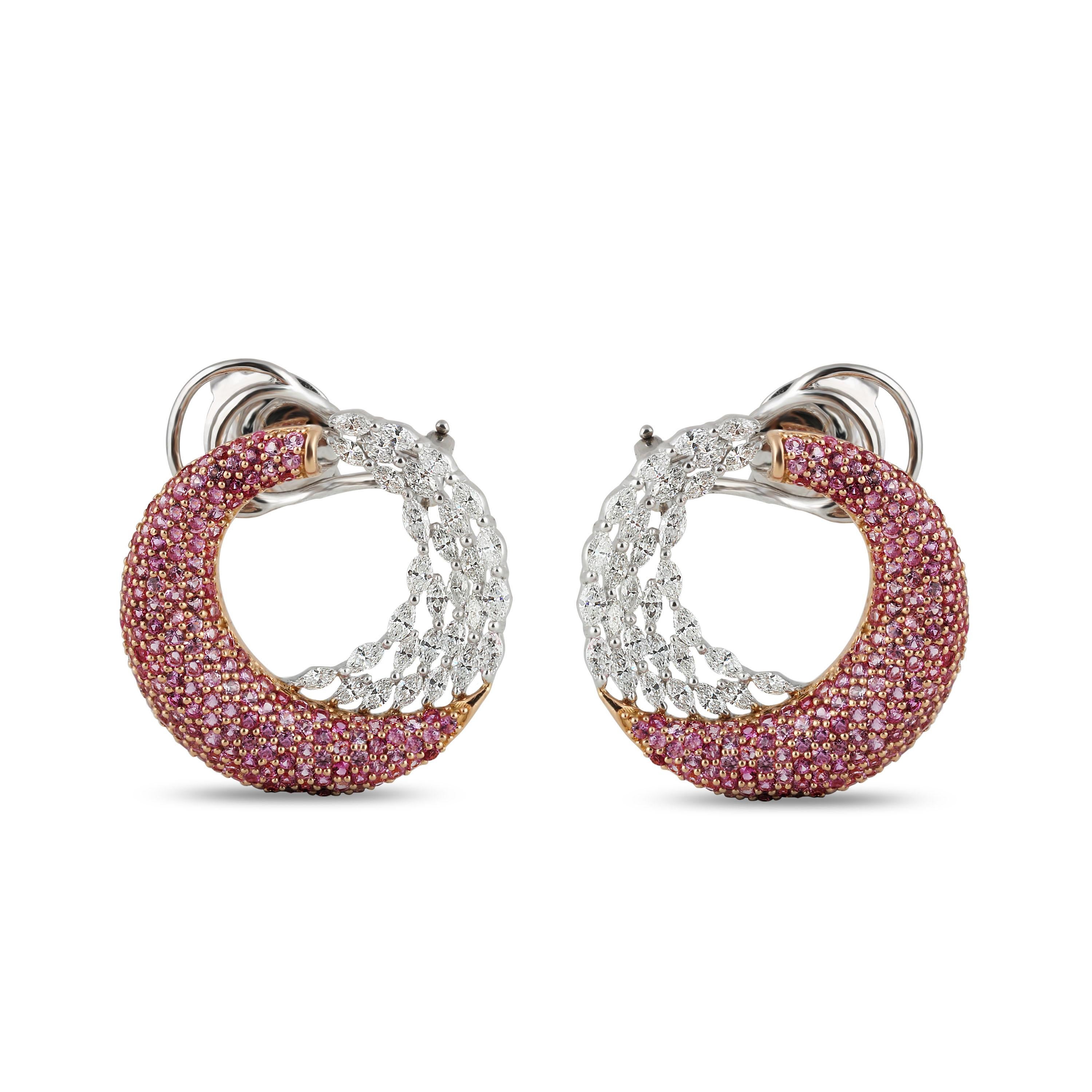 Brilliant cut diamonds and pink sapphire earrings 

It is the ingenious amalgamation of meticulously selected brilliant cut marquise diamonds and pink sapphires that gives these broad hoops its aura of unique artistry. The 320 stones have been used
