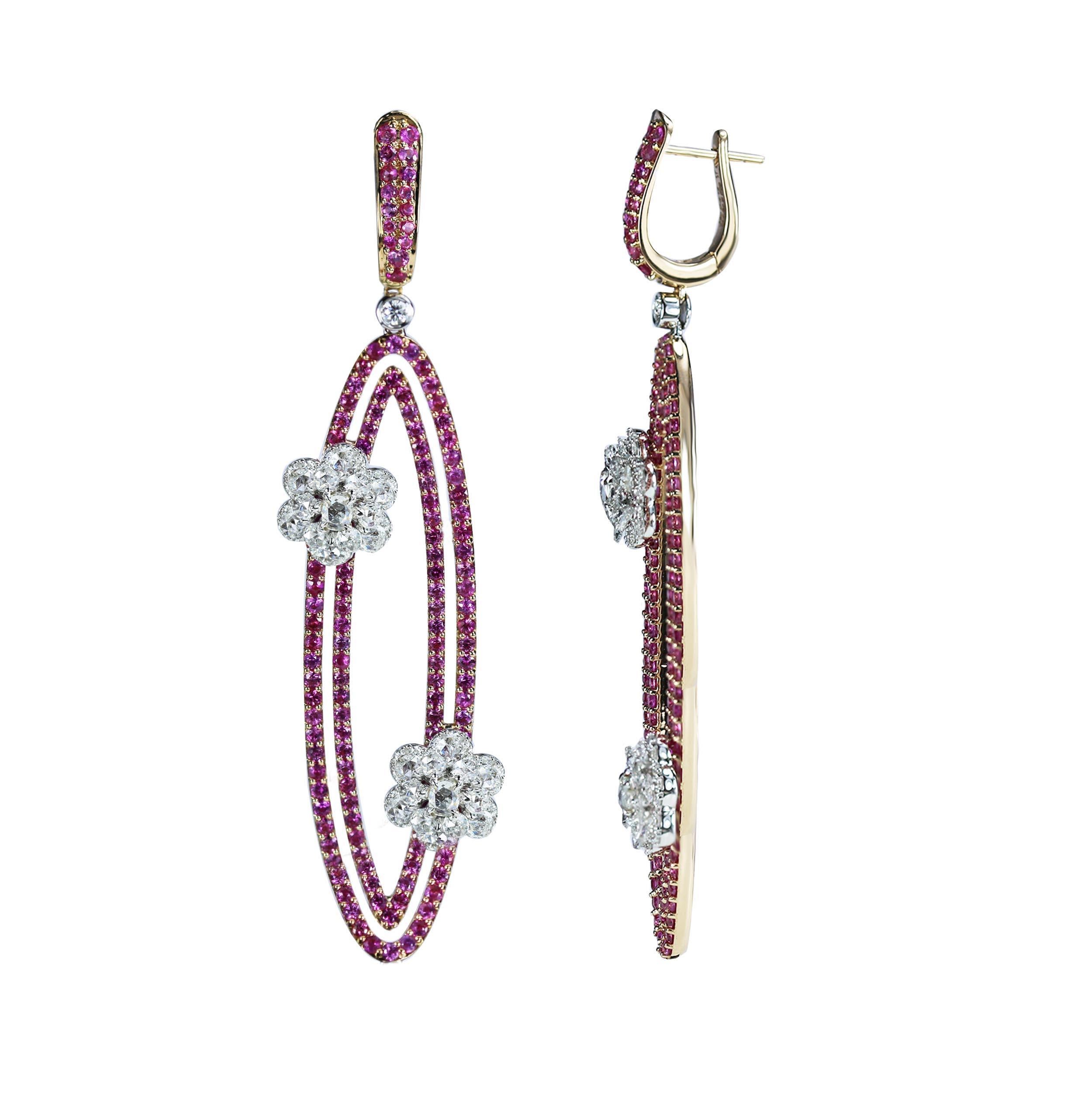 Diamond and Pink Sapphire Earrings

Geometry and nature inspirations come together in these earrings that are one for the ages. Beaded pink sapphires form oval loops that are brought together with floral motifs composed of round, oval, rose cut and