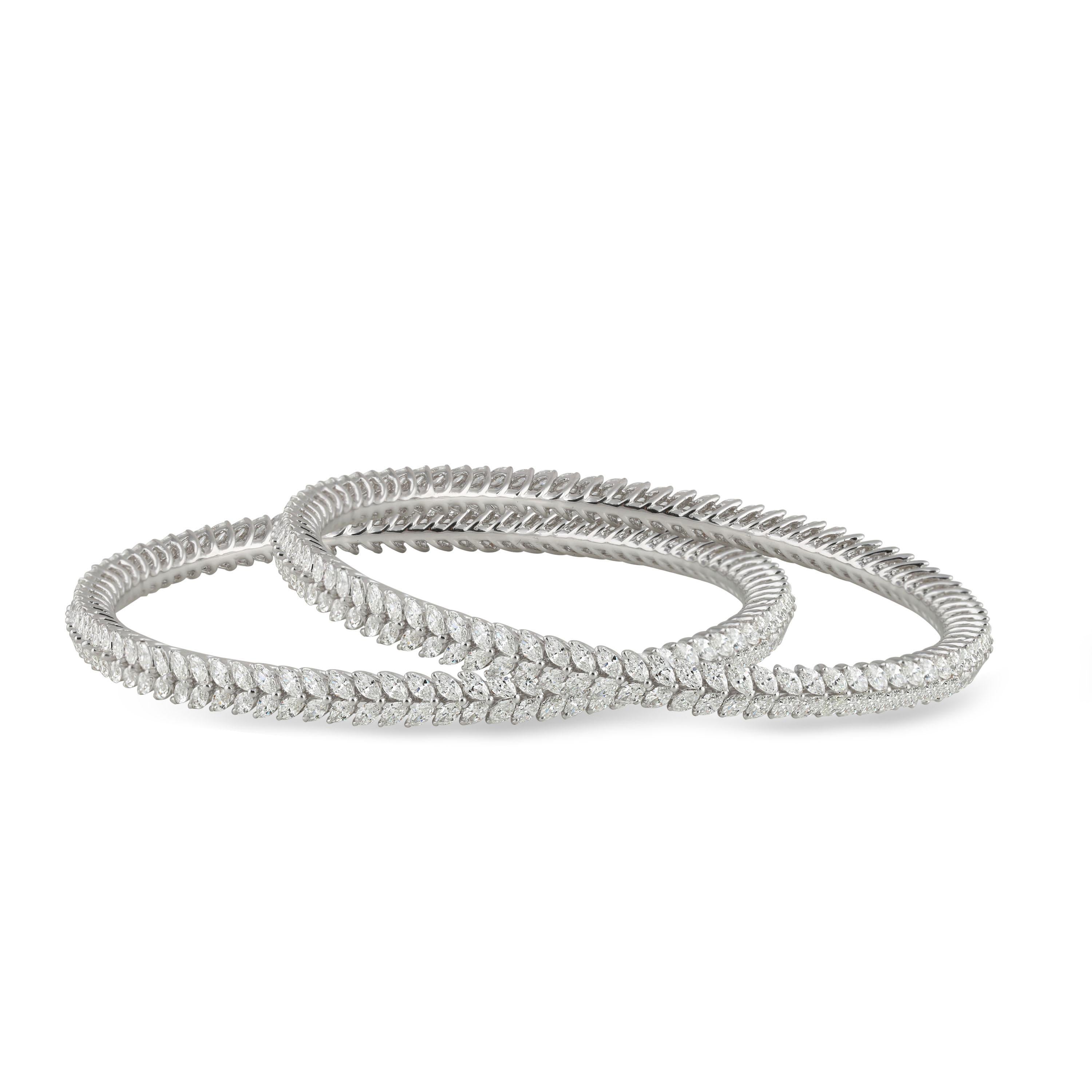 The beautiful placement of marquise brilliant cut diamonds that mimic the formation of nature's finest creation – leaves – is the reason for the elegance of these 18K white gold bangles. Featuring 352 stones, this is a pair that stands the test of