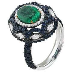 Studio Rêves Oval Emerald with Diamonds and Blue Sapphire Ring in 18 Karat Gold