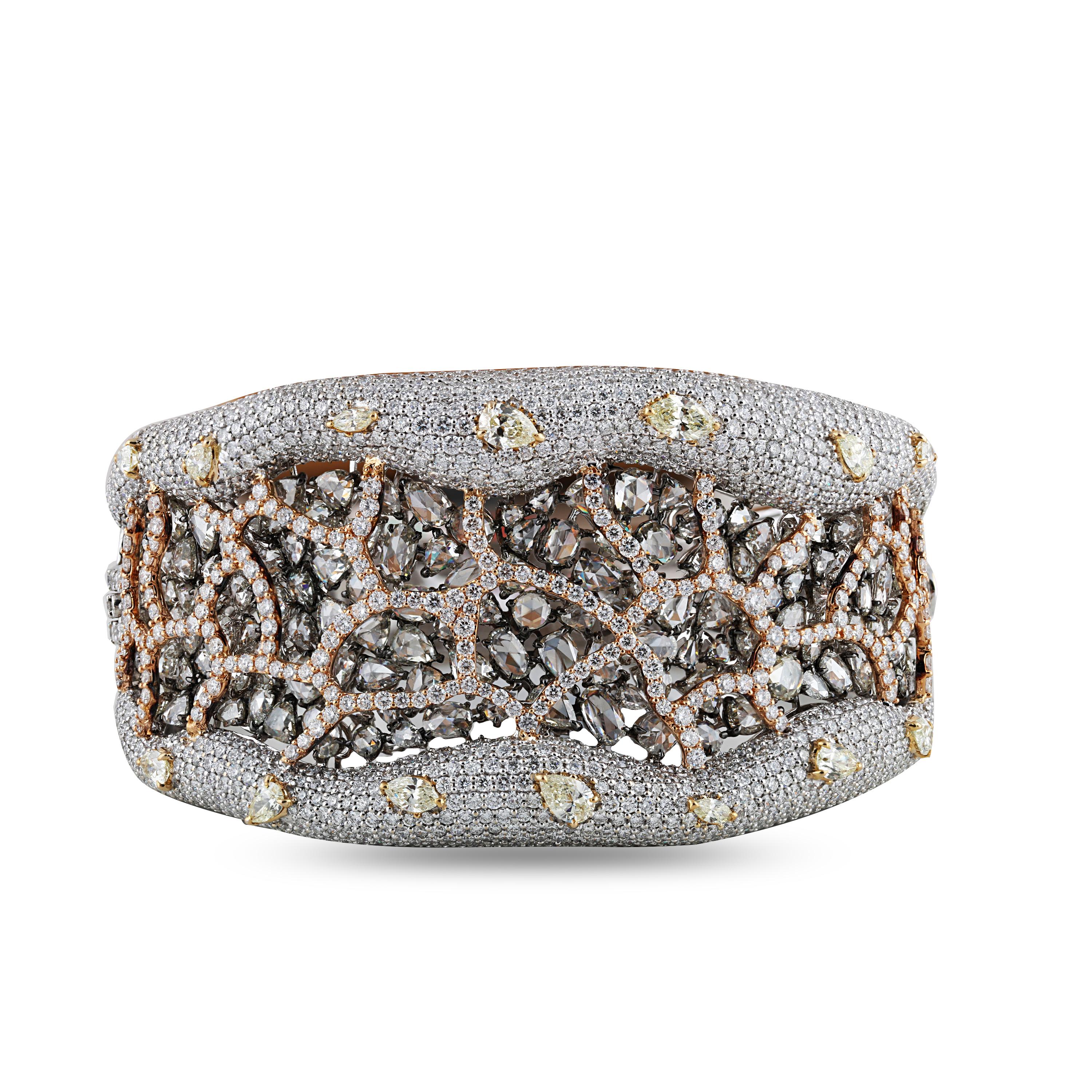 Brilliant cut and Rosecut diamond bracelet

The unconventional asymmetrical approach gives this broad diamond bracelet its standout quality. Composed of 1,613 brilliant cut and rose cut white and fancy yellow diamonds in brilliant cut and rosecut