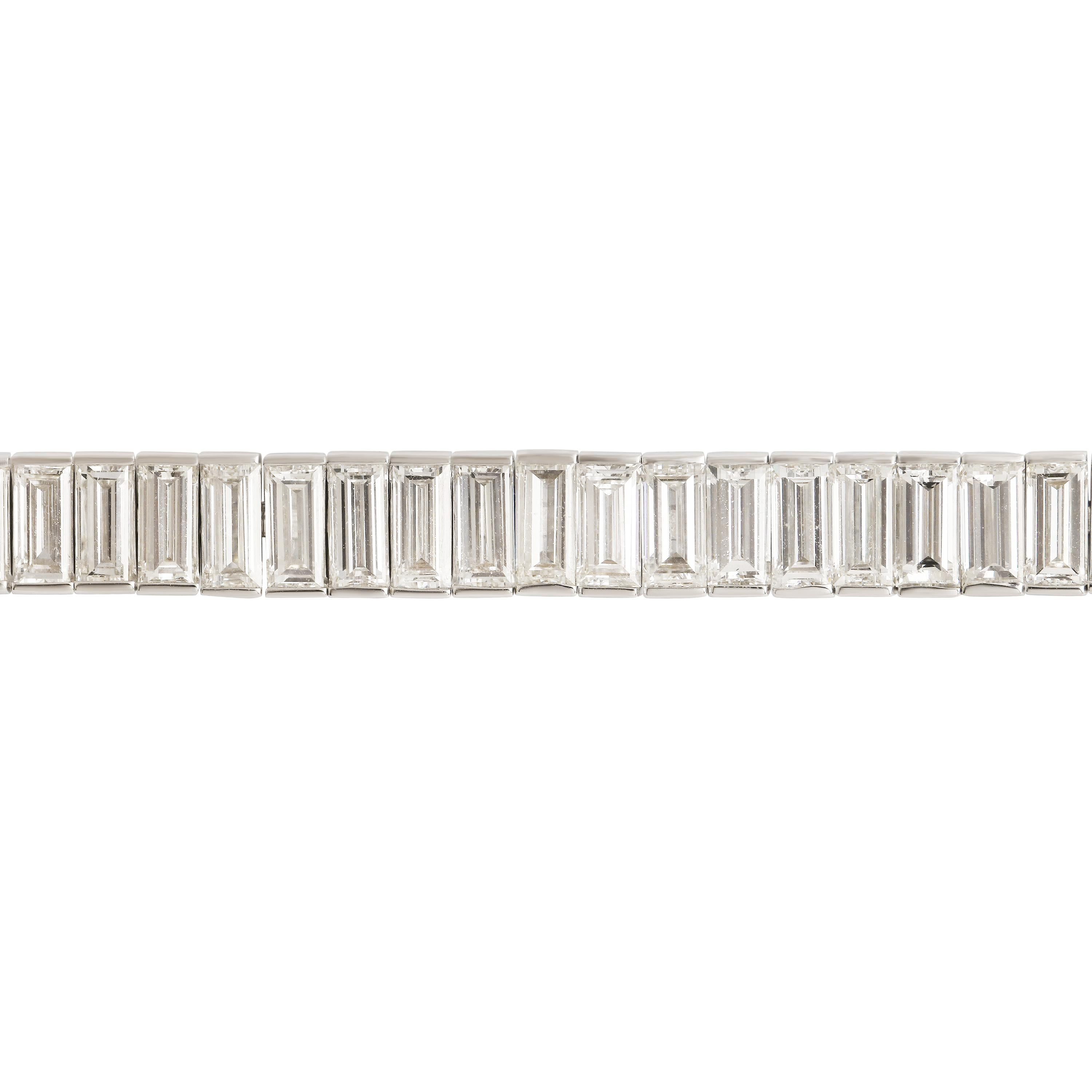 A celebration of refined brilliance, this elegant tennis bracelet features 10.65 carats of perfectly matched baguette-cut diamonds, each aligned in a seamless channel of light. Set in 18K white gold, the bracelet offers a sleek, modern silhouette