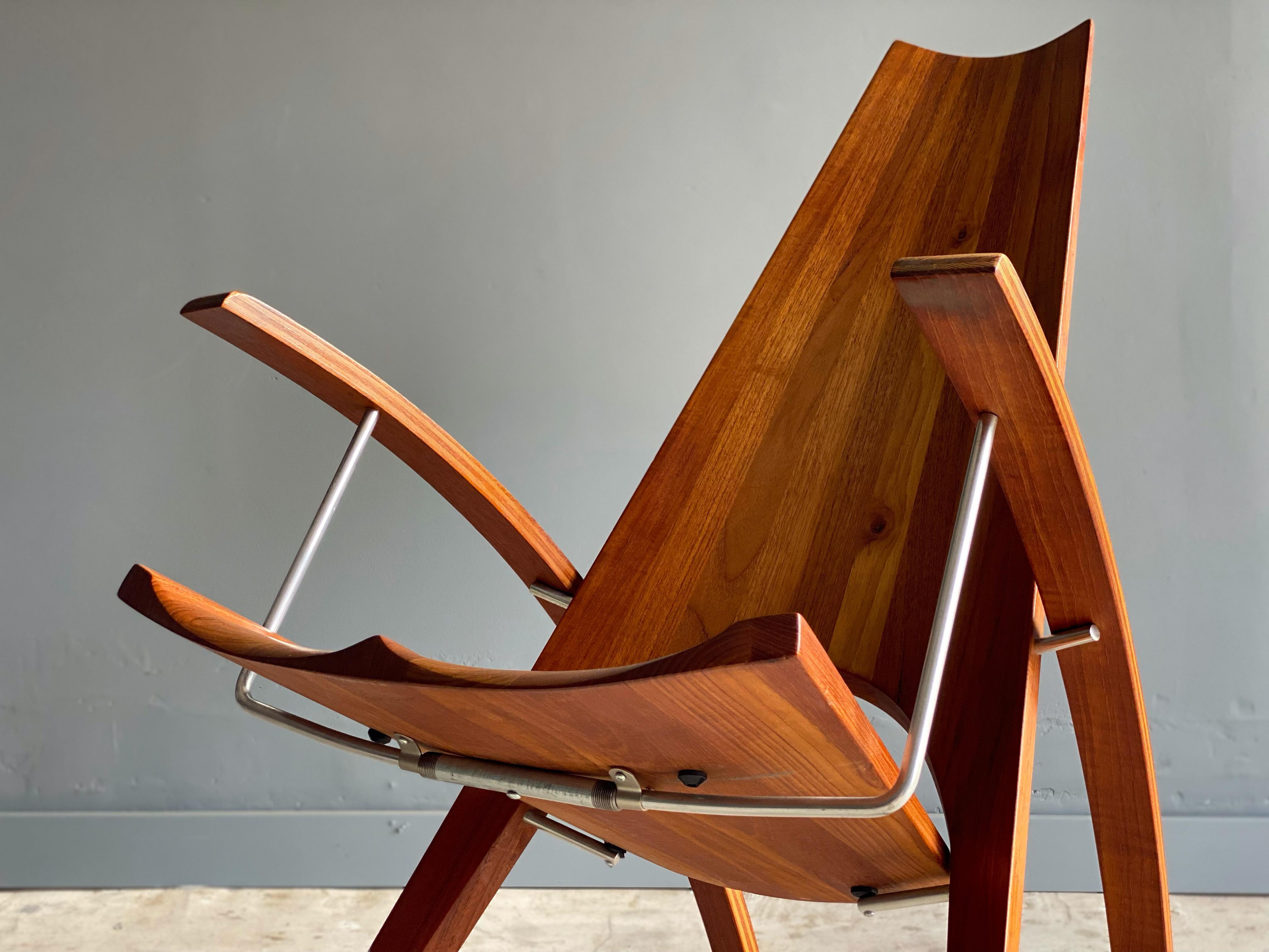 Stunning mid century studio rocking chair designed by Leon Meyer. Leon Meyer was a California architect most notably known for his Bay Area “round houses” during the 1960s. This example is hand crafted in solid teak with metal supports. Pencil